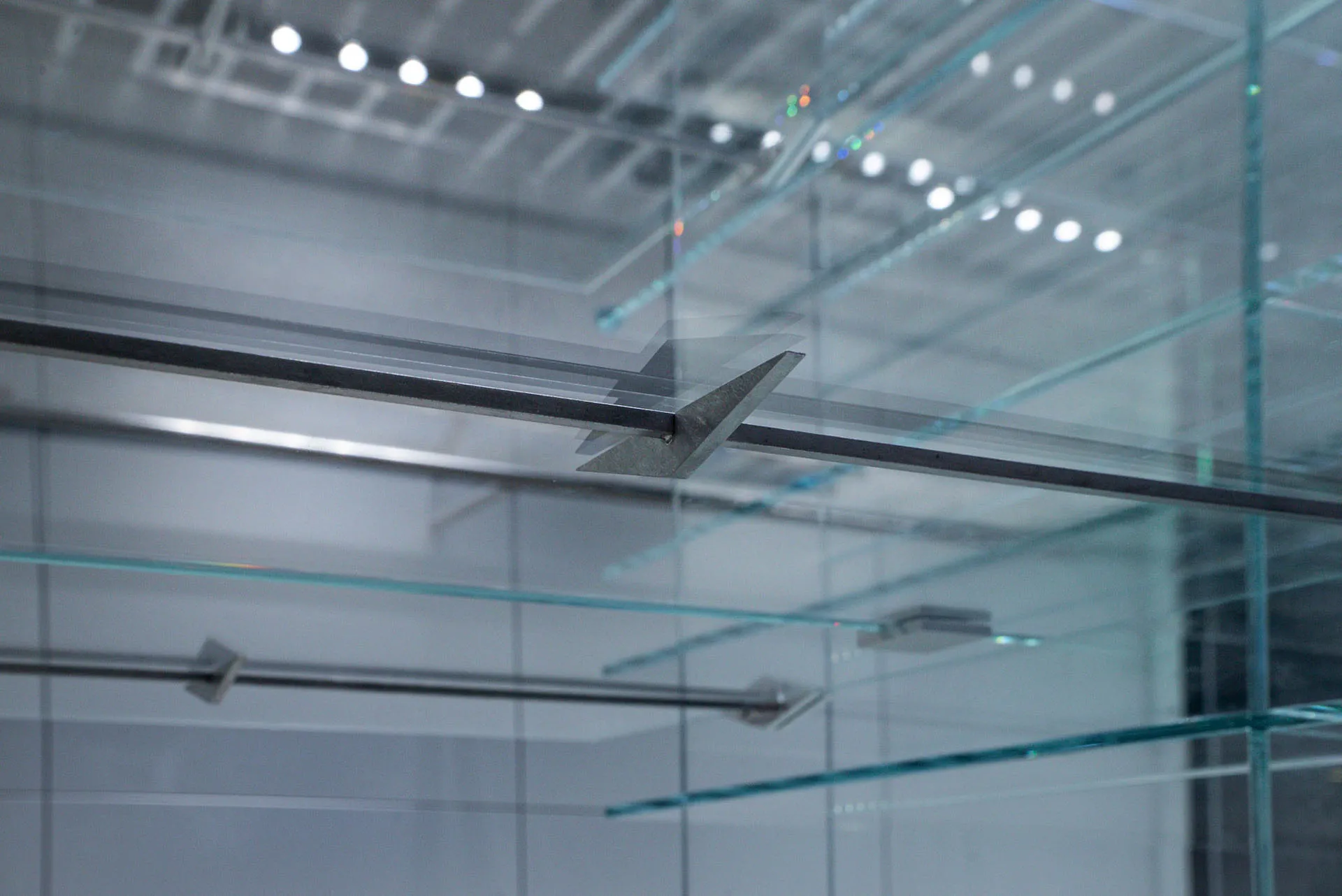 Modern industrial interior featuring glass, metal, and steel structural elements.
