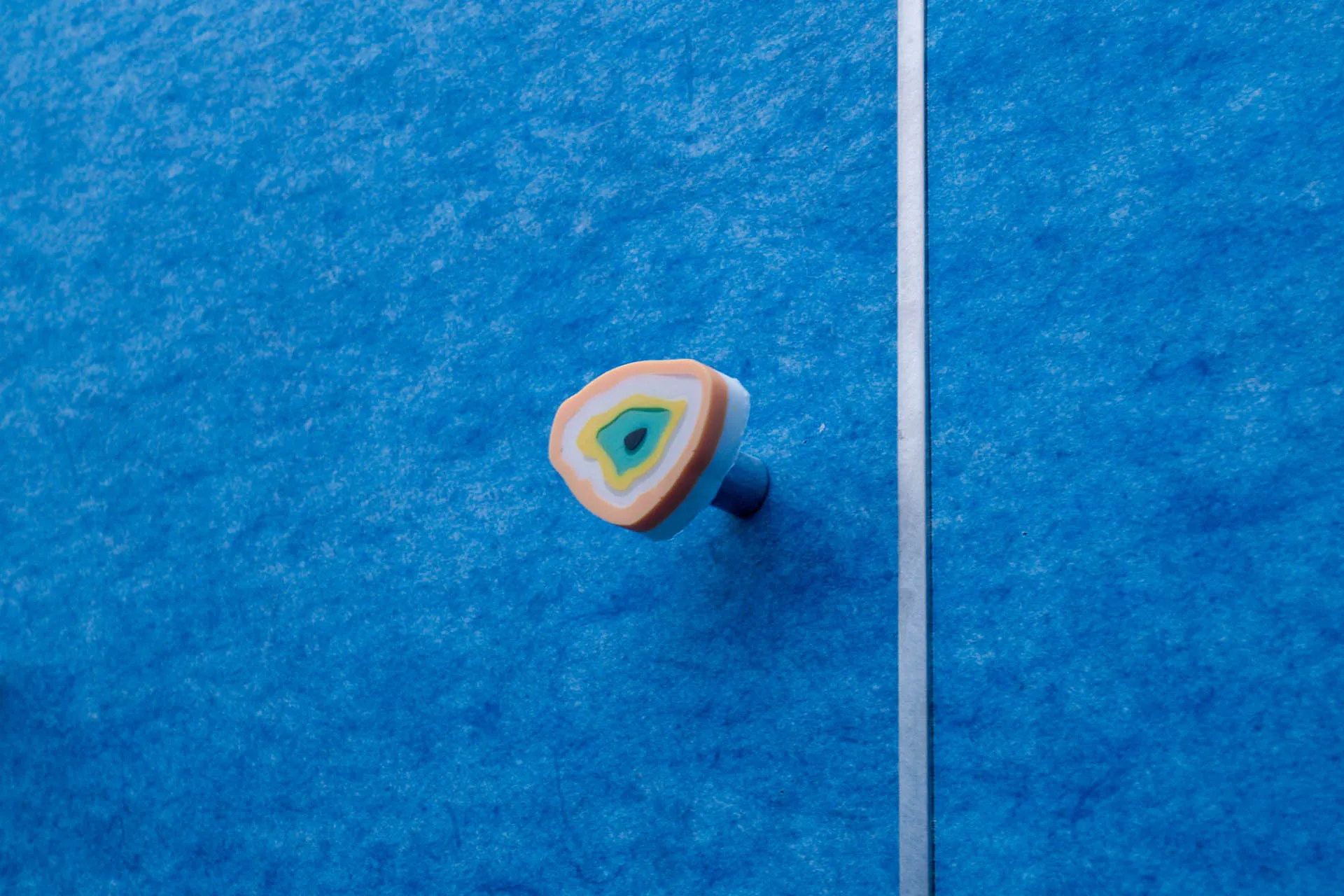 Minimalist DIY ceramic drawer handle in orange, yellow, and teal colors