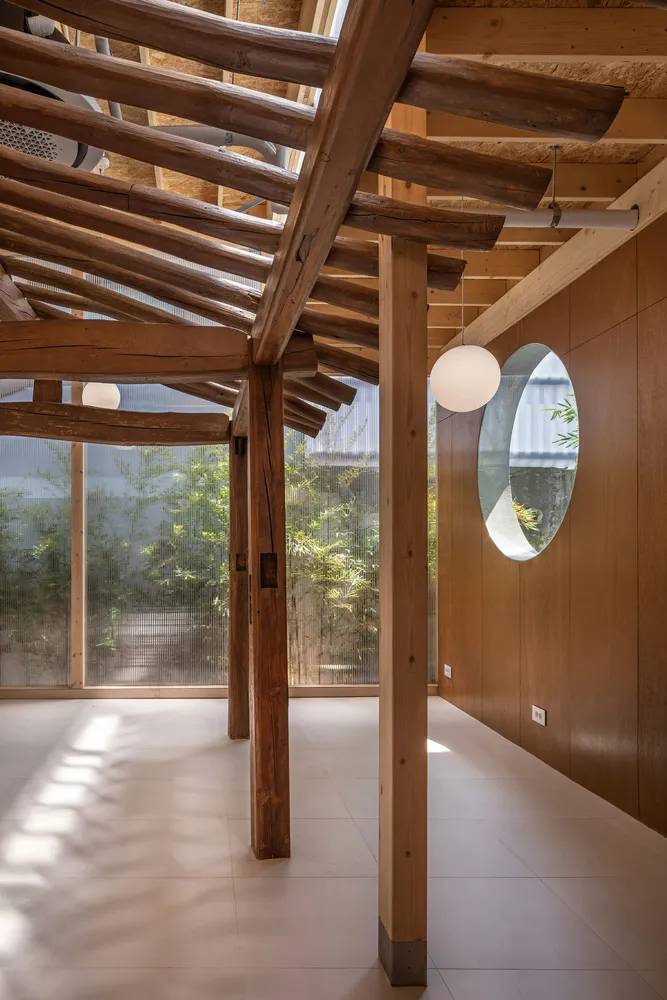 Minimalist interior space featuring wooden beams and walls.