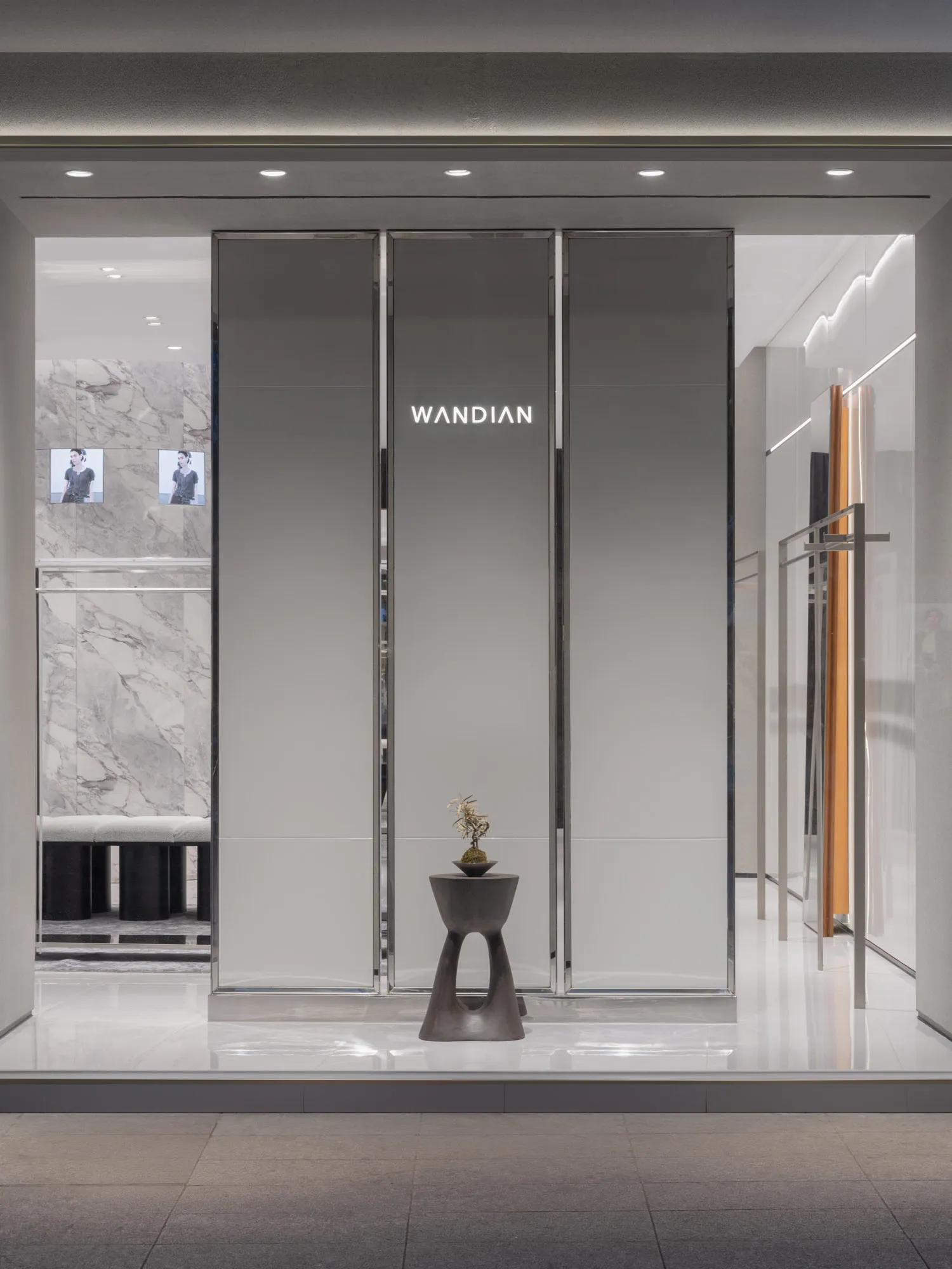 A minimalist storefront with glass panels and modern design features.
