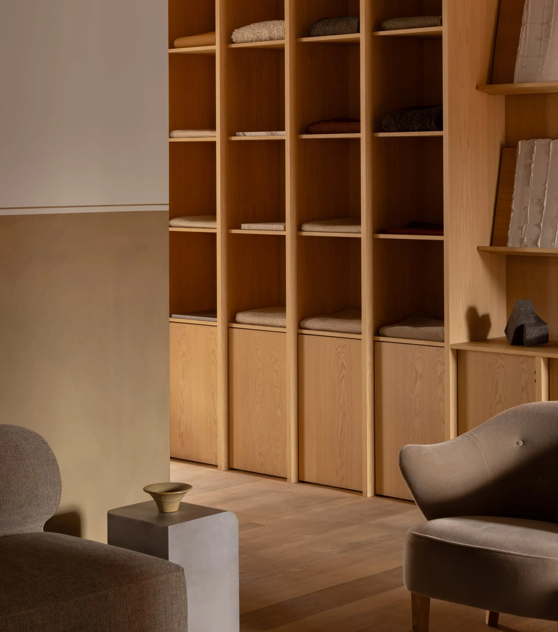 A modern minimalist living room featuring wooden elements.