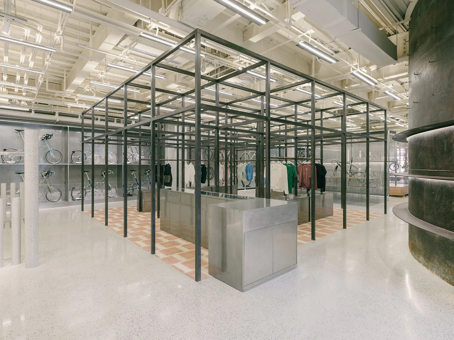 An industrial-style retail clothing shop with a steel frame and corrugated metal walls.