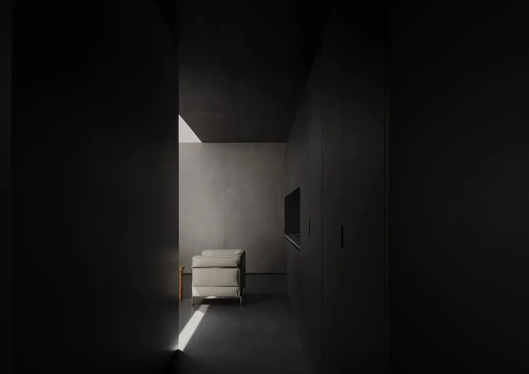 A minimalist living room featuring concrete walls, a single white armchair, and a television.