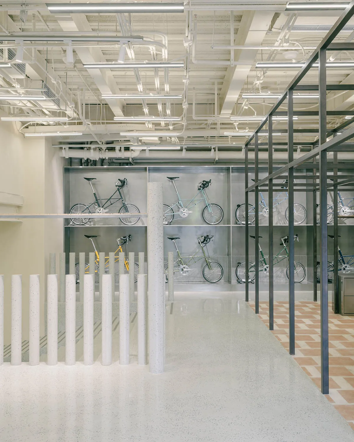 Modern industrial interior space featuring a bicycle display with concrete and metal elements.