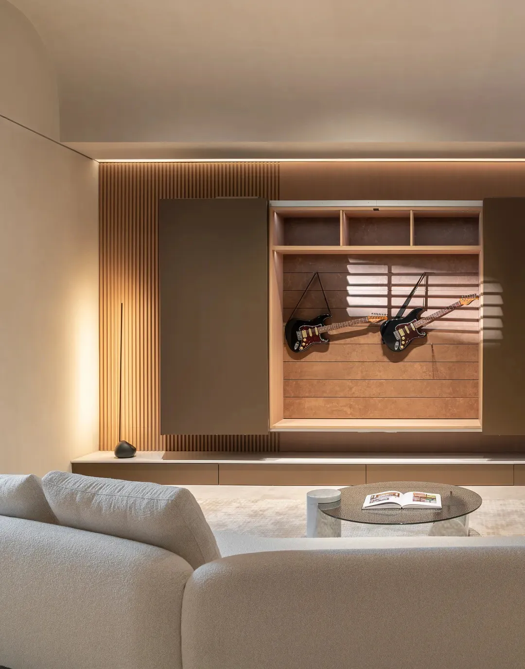 A modern living room features wooden paneling and a guitar display. The interior design showcases contemporary design element
