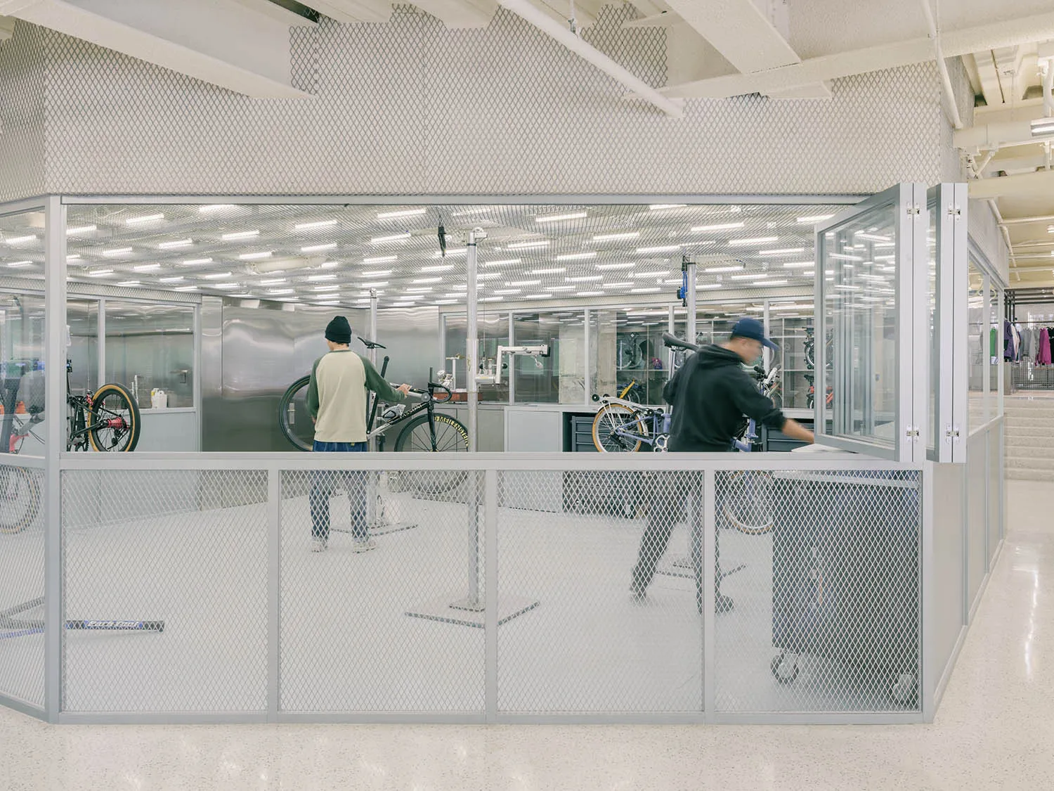 Industrial-style workspace with glass dividers and metal elements.