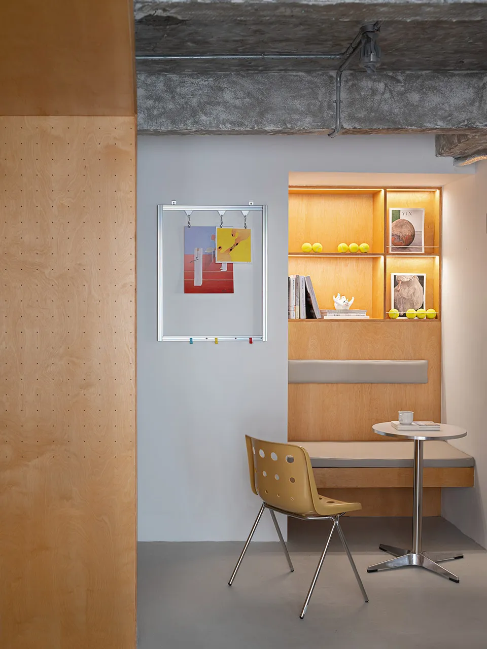 A minimalist office space featuring natural wood elements and a small desk with a chair.