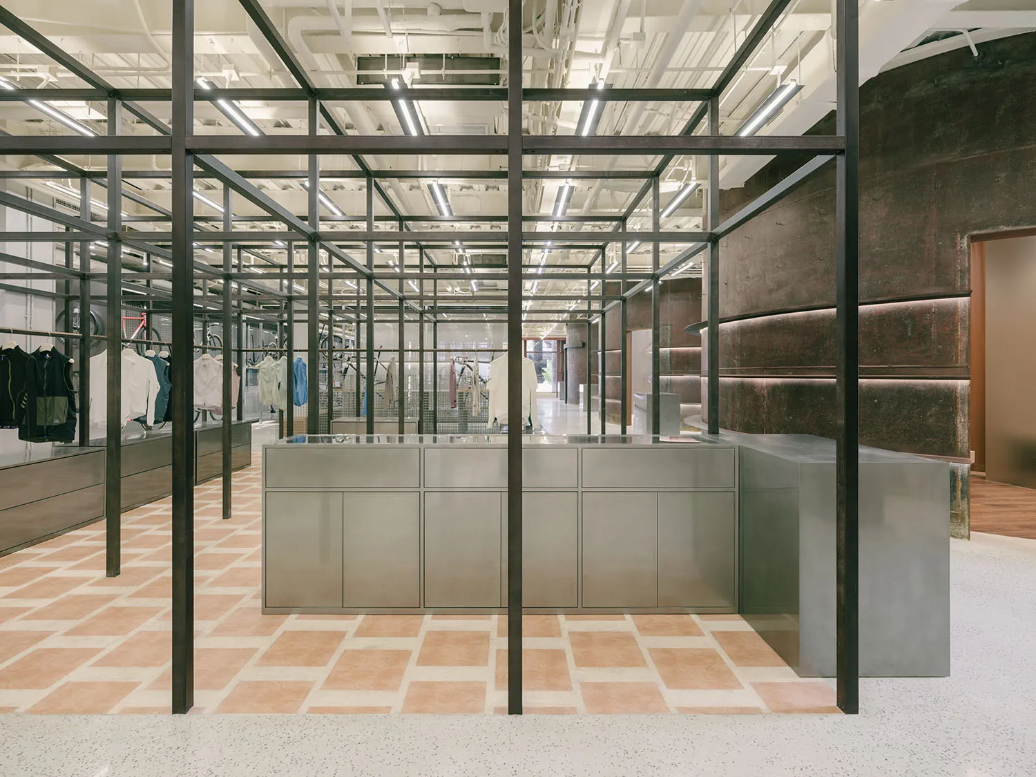 Modern minimalist retail display featuring steel, glass, and concrete elements.