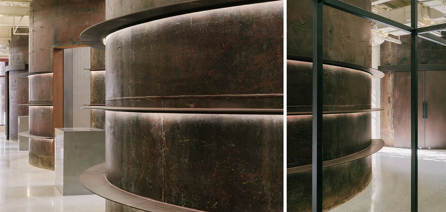 Modern industrial design features metal, steel, and concrete materials in a corporate space reception.