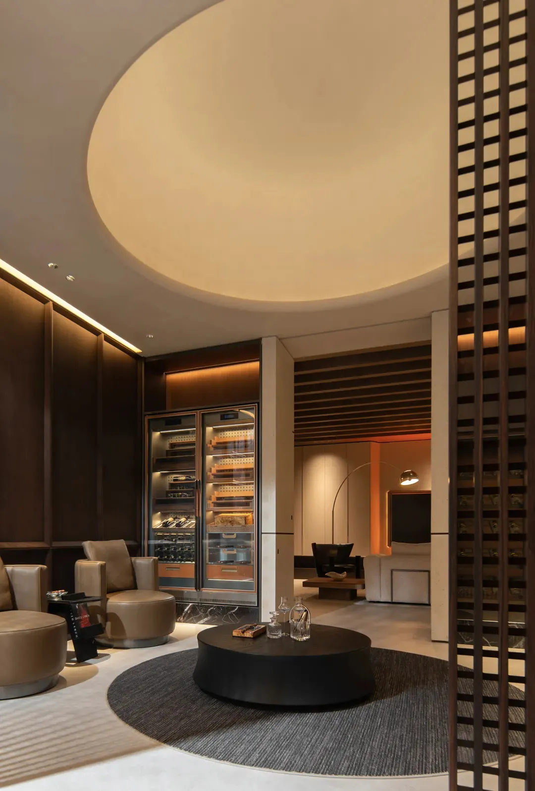 A modern living room featuring concrete flooring and sleek furniture.