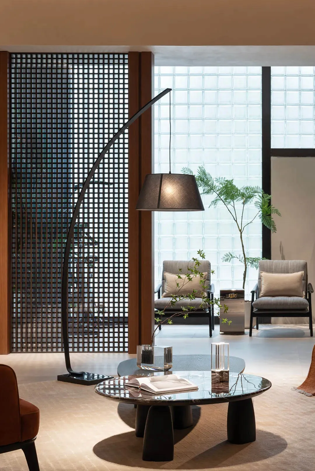 A modern, minimalist living room with metal, wood, and glass materials and a simple, functional design.