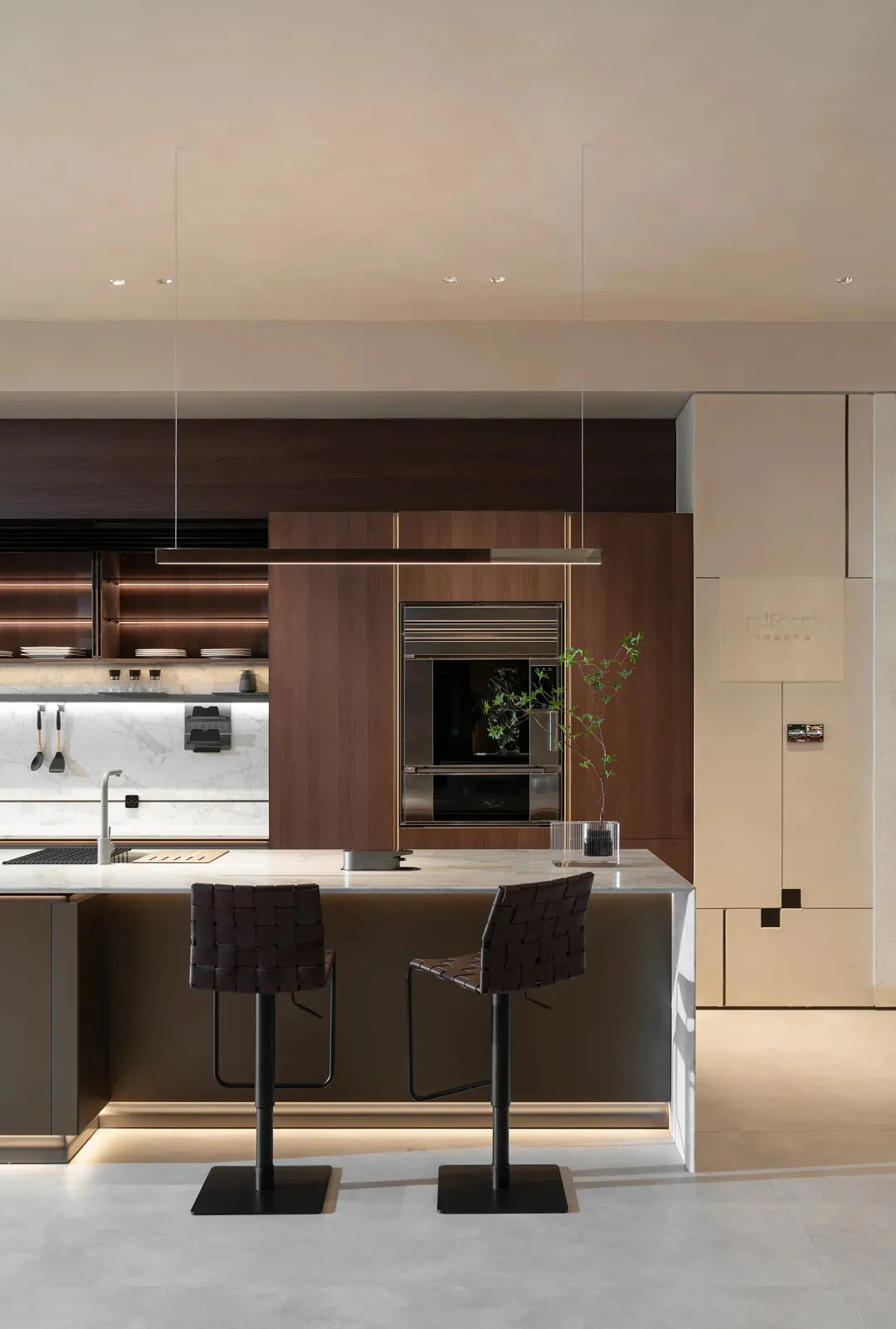 A modern kitchen interior with wooden cabinets and marble countertops.