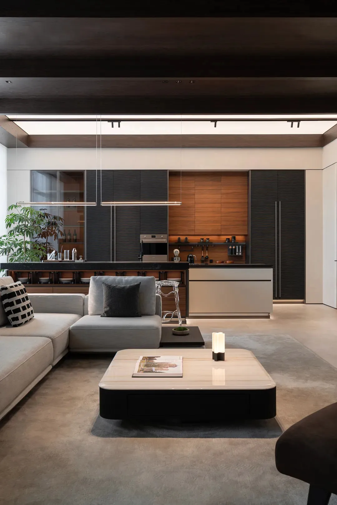 Modern living room with minimalist design, wooden accents, and a glass coffee table.