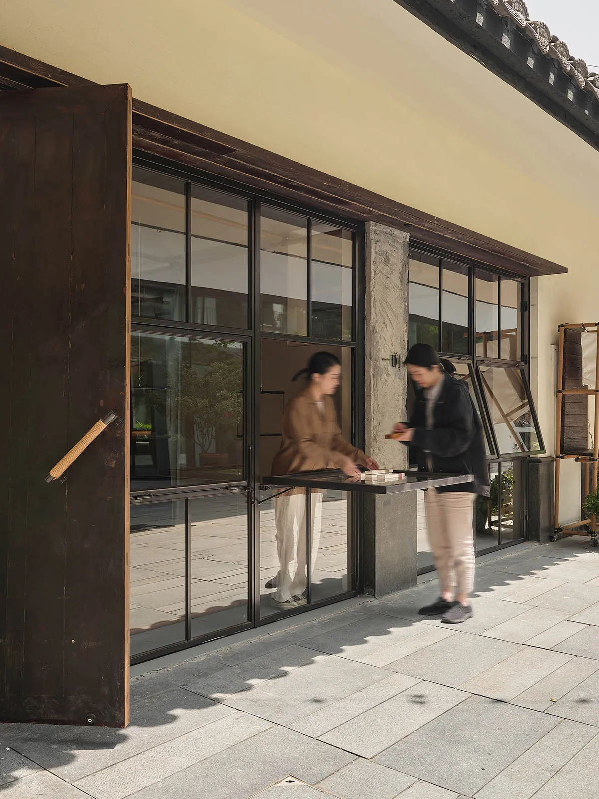 A modern storefront with large glass windows and wooden accents.