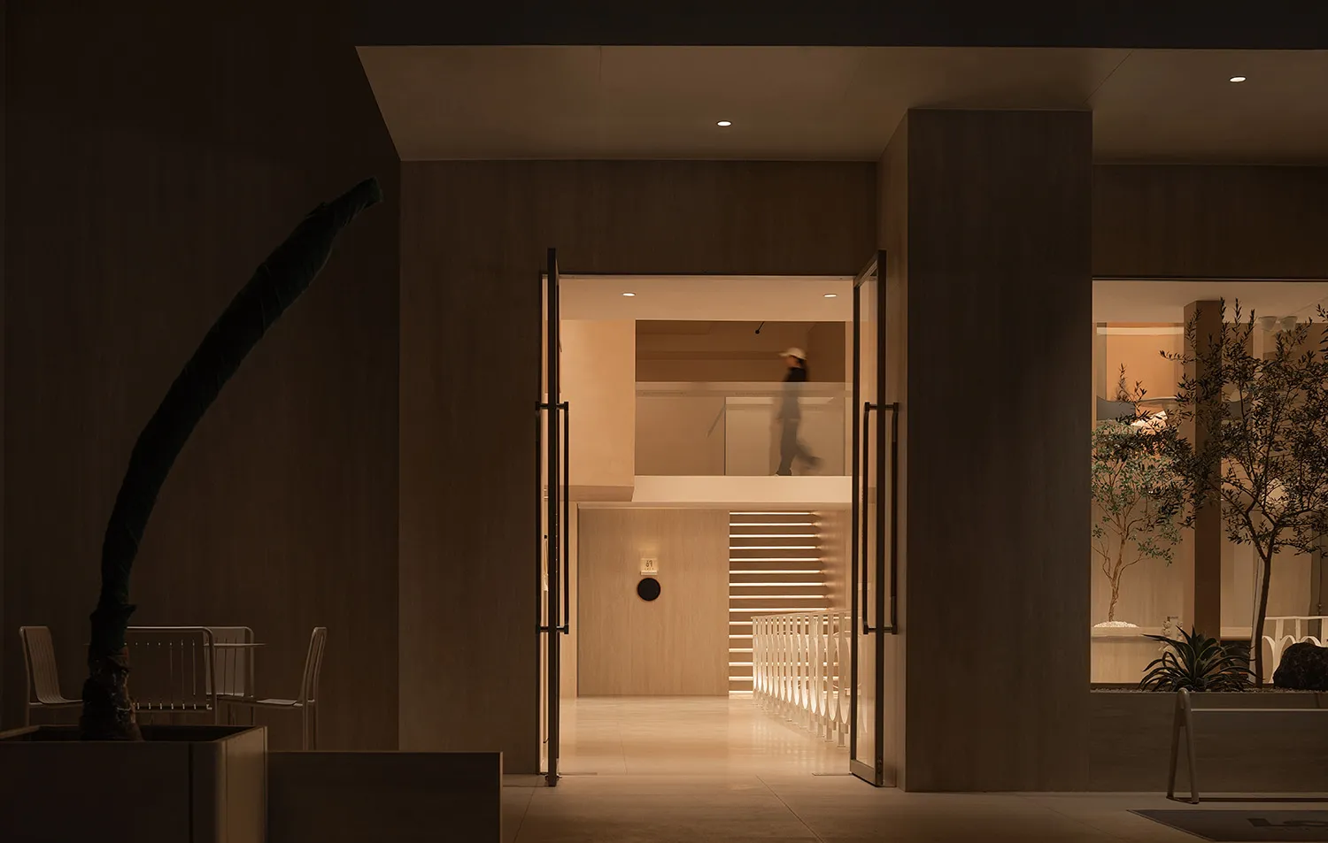 Modern lobby with wooden interior design and sleek, minimalist architecture.