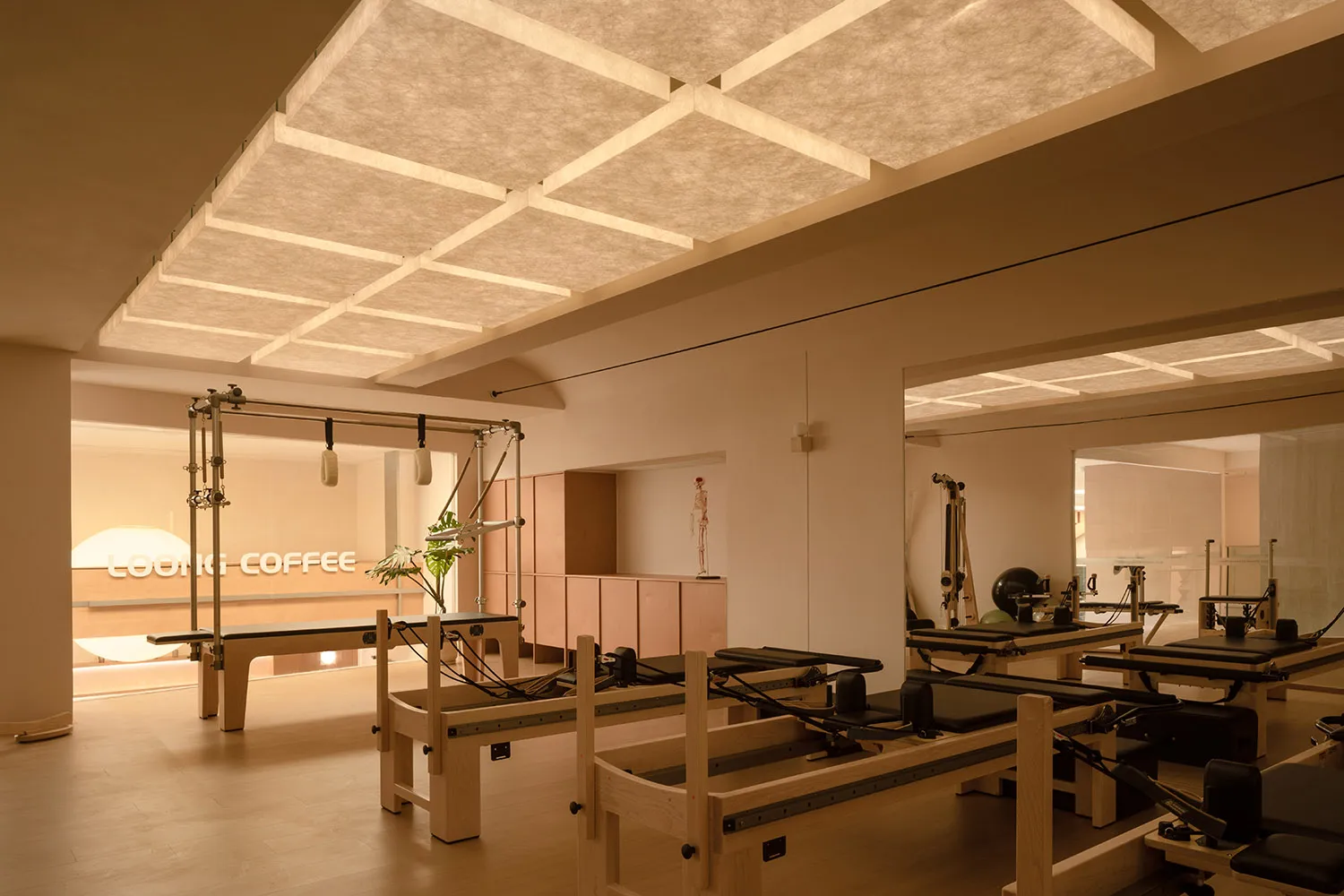 Modern minimalist fitness center with wooden equipment and clean lines.