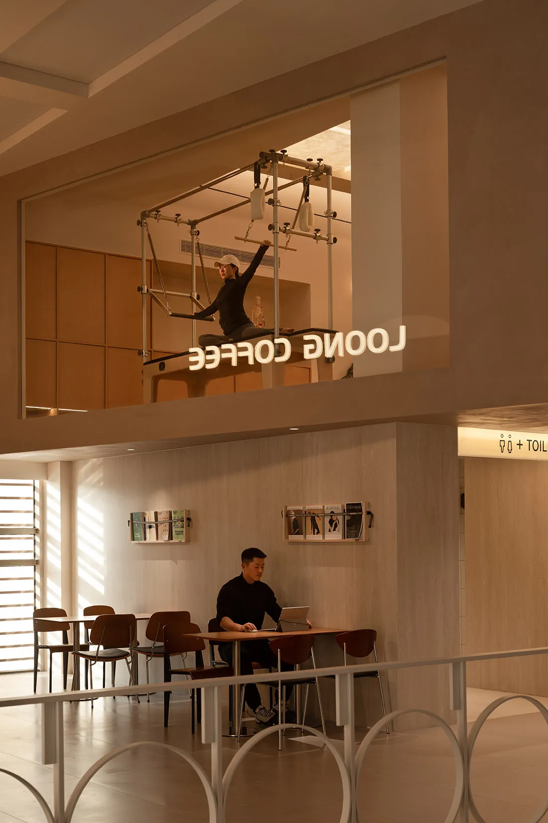 A modern coffee shop featuring industrial design elements, with a wooden counter and metal fixtures.