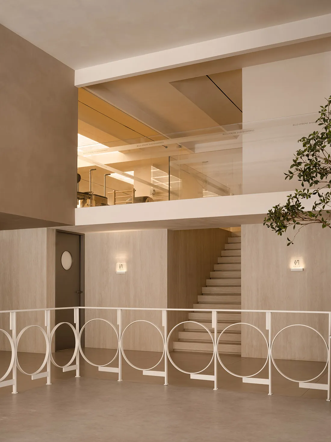 Modern, minimalist lobby featuring exposed concrete and wooden elements.