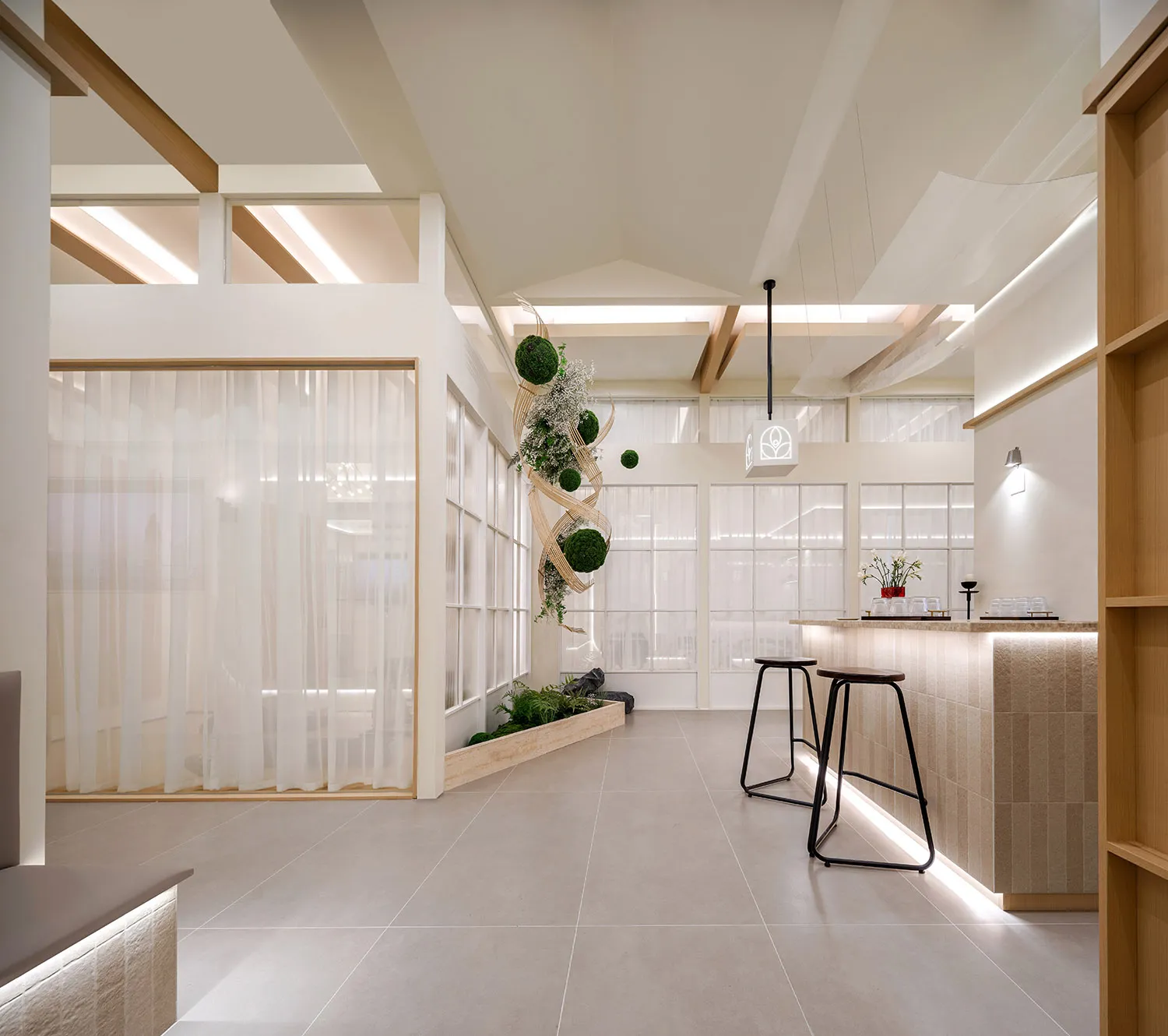 A minimalist restaurant interior featuring glass elements, concrete walls, and wooden accents.