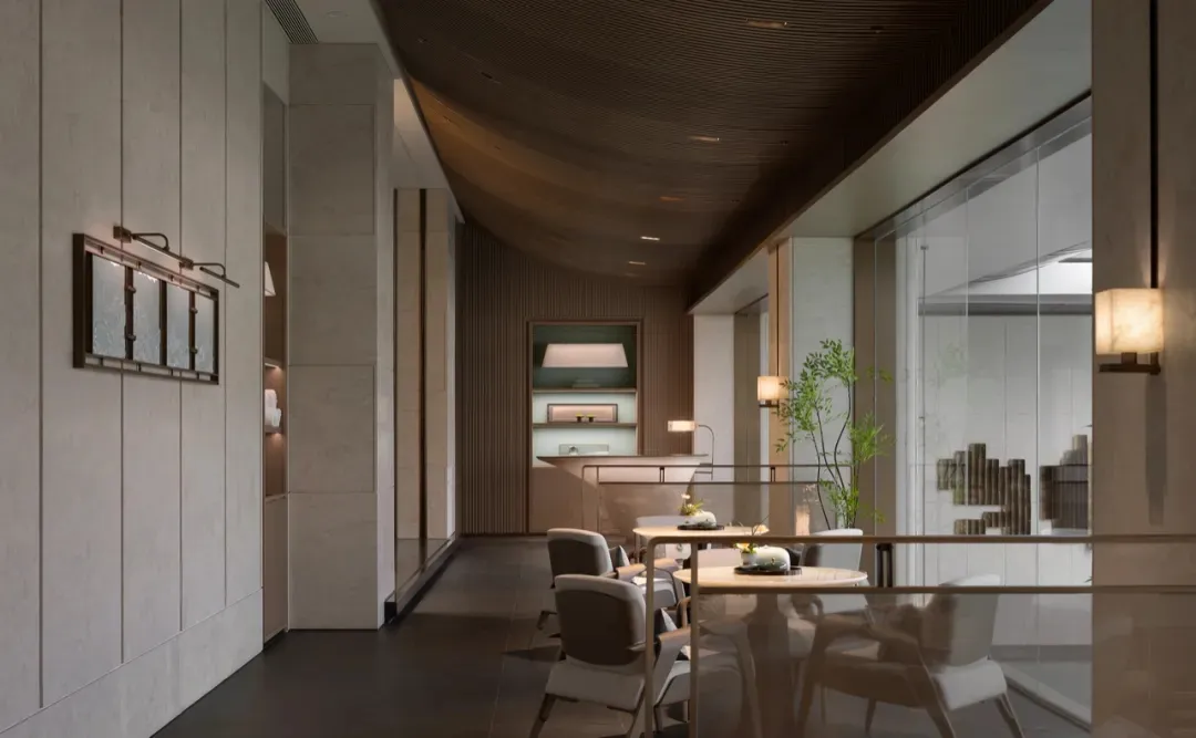 A sleek, minimalist restaurant interior featuring concrete, wooden, and glass materials and a contemporary design.