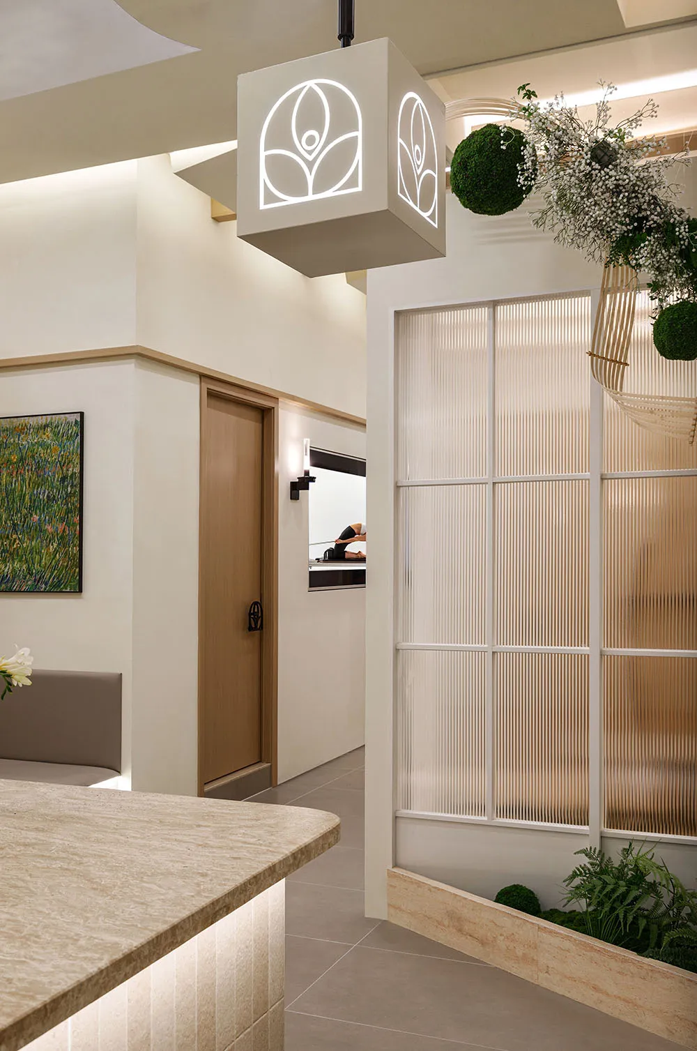 Spacious and sleek spa interior designed with modern materials such as glass and wood.