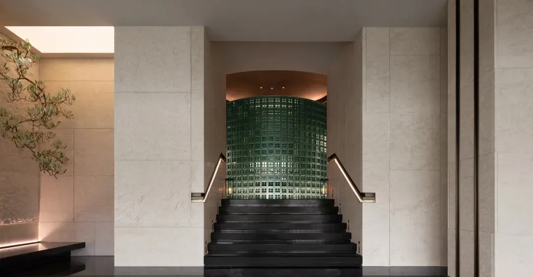 A modern architectural indoor entryway with glass features.