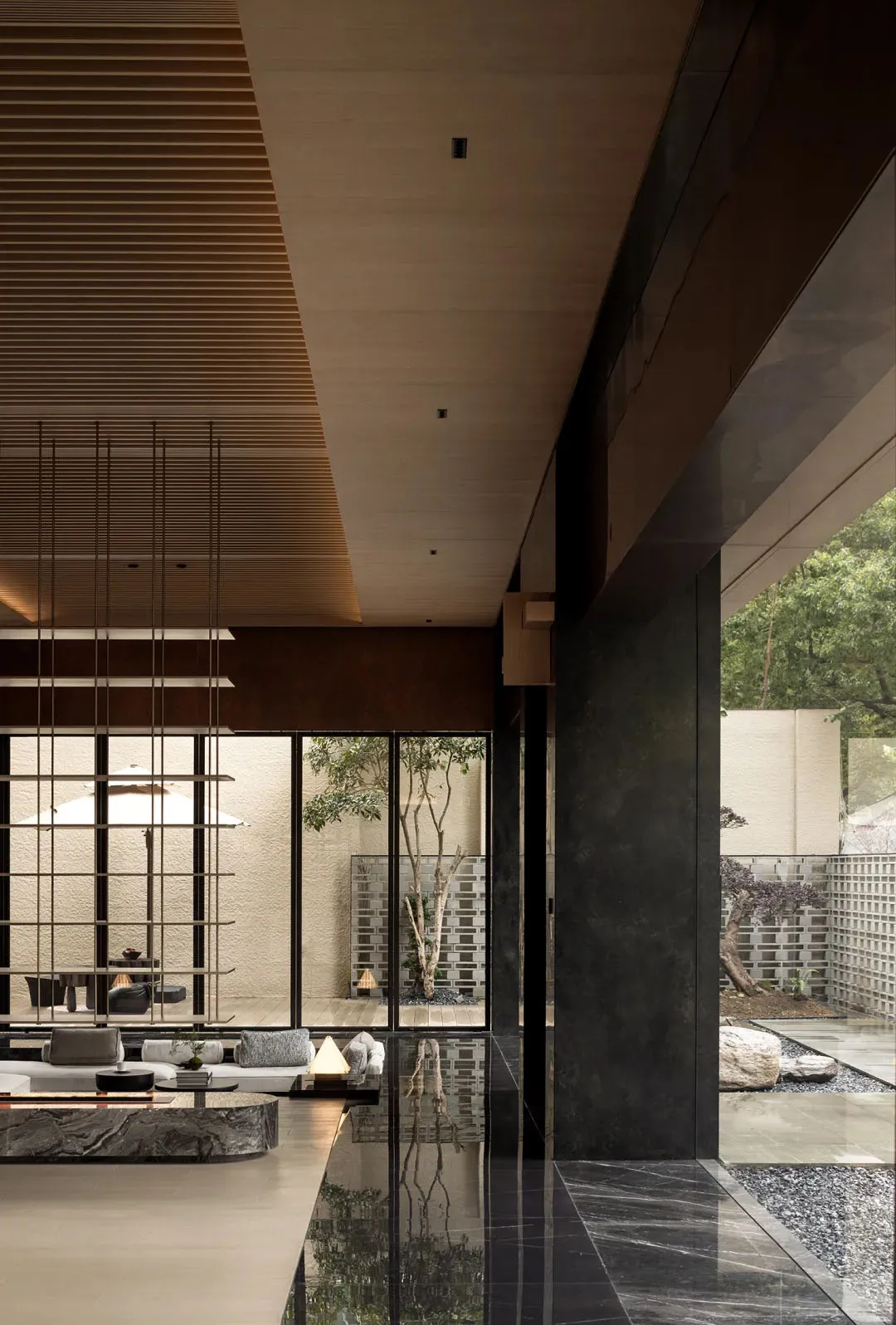 A modern living room featuring marble and glass elements.
