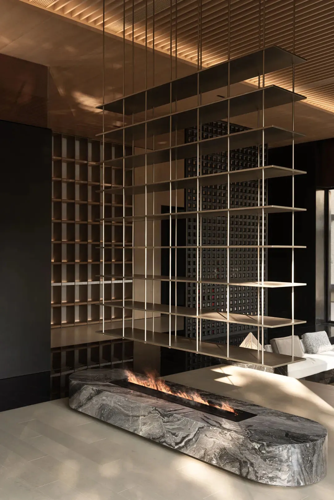 A modern living room with metal floating shelves and a marble fireplace.