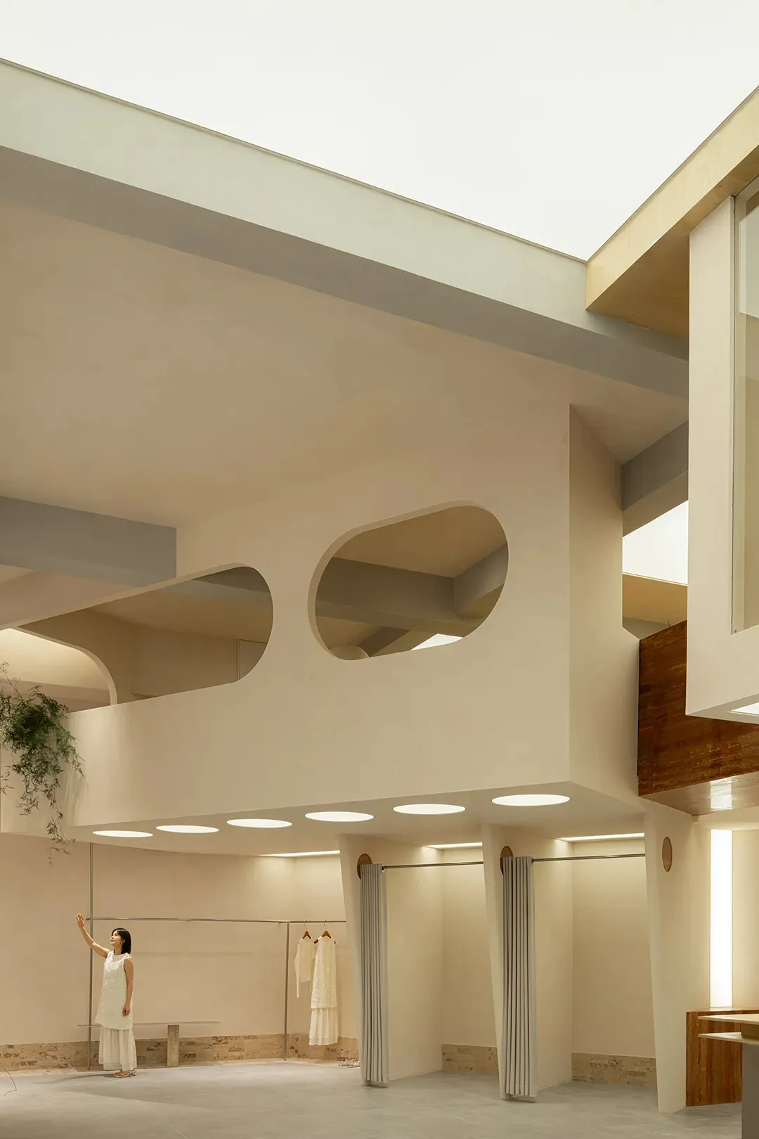 A modern minimalist interior space with concrete walls, an open ceiling, and minimalist fixtures.