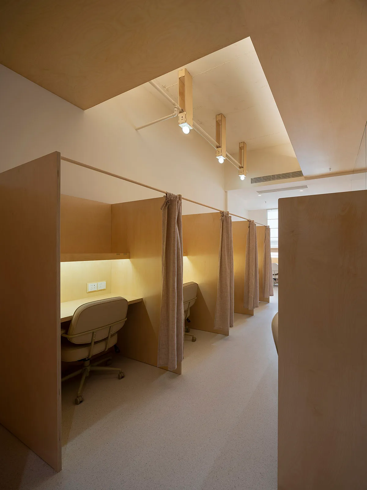 Modern minimalist office cubicles with wood panels and curtains