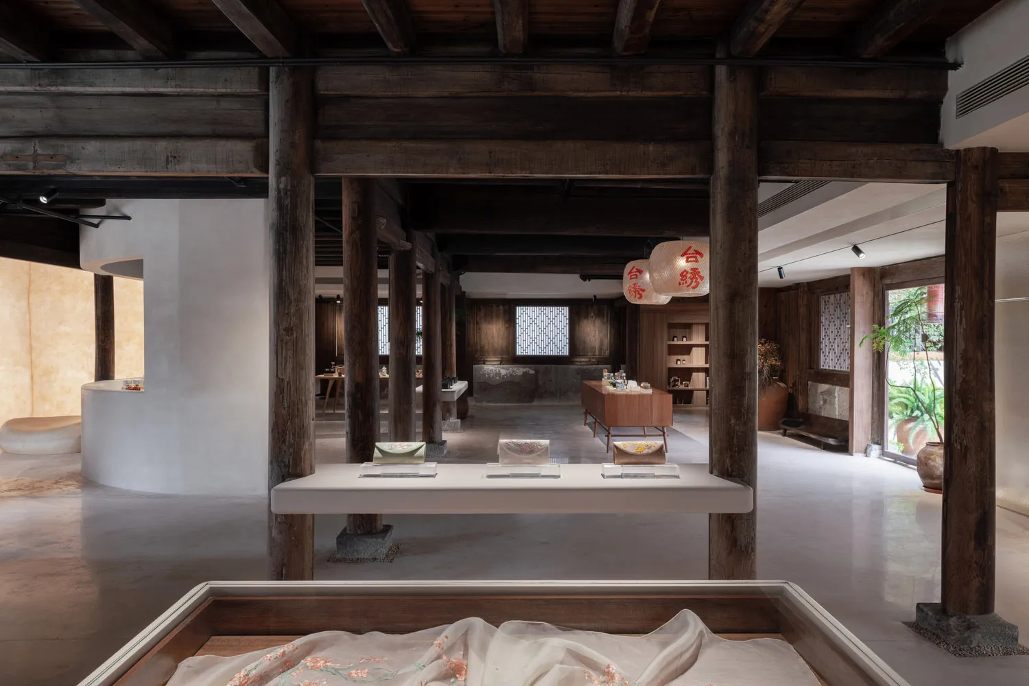Modern interior space featuring wooden beams and concrete flooring.