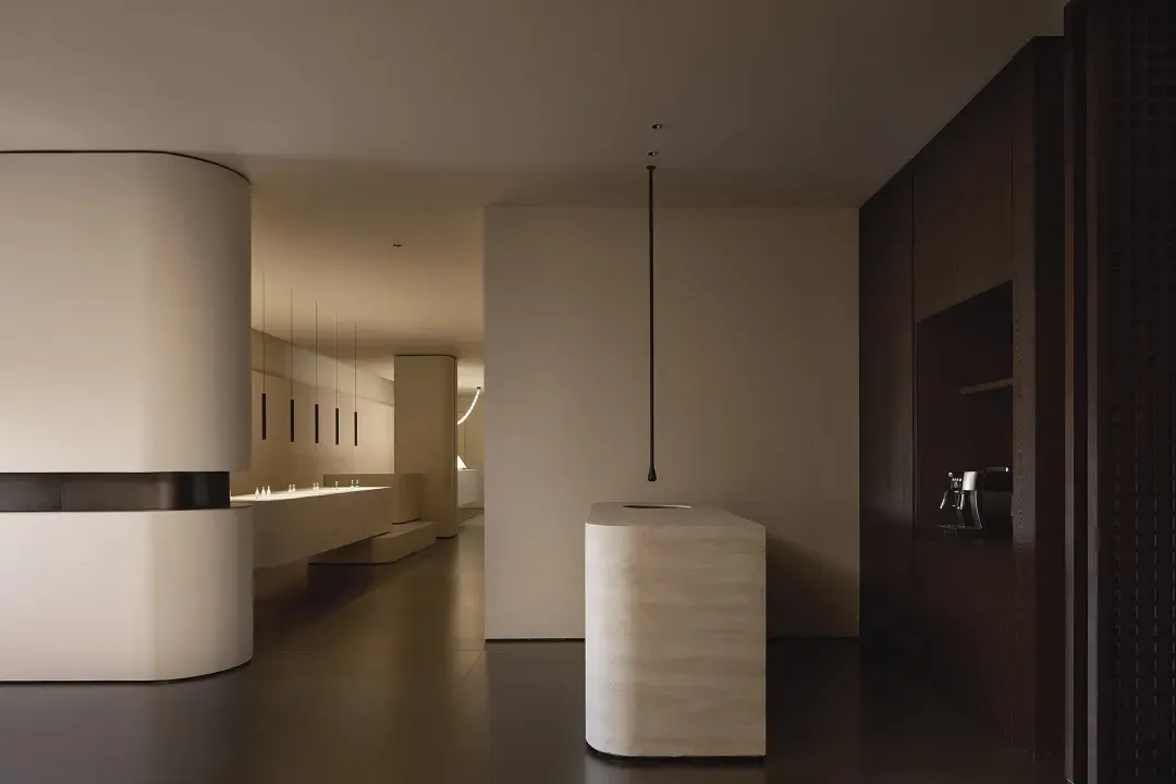 A modern interior space with minimalist design elements featuring concrete and wood materials.