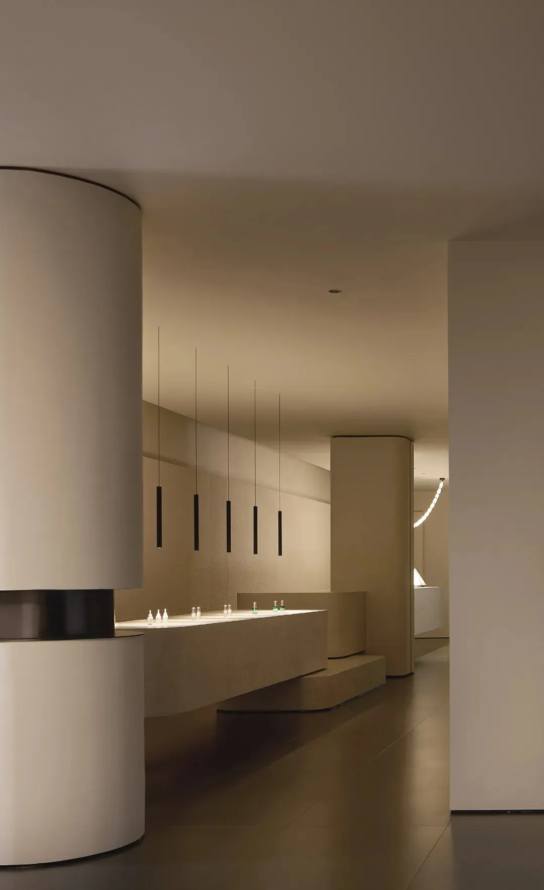 A modern retail storefront featuring minimalist design and concrete finishes.