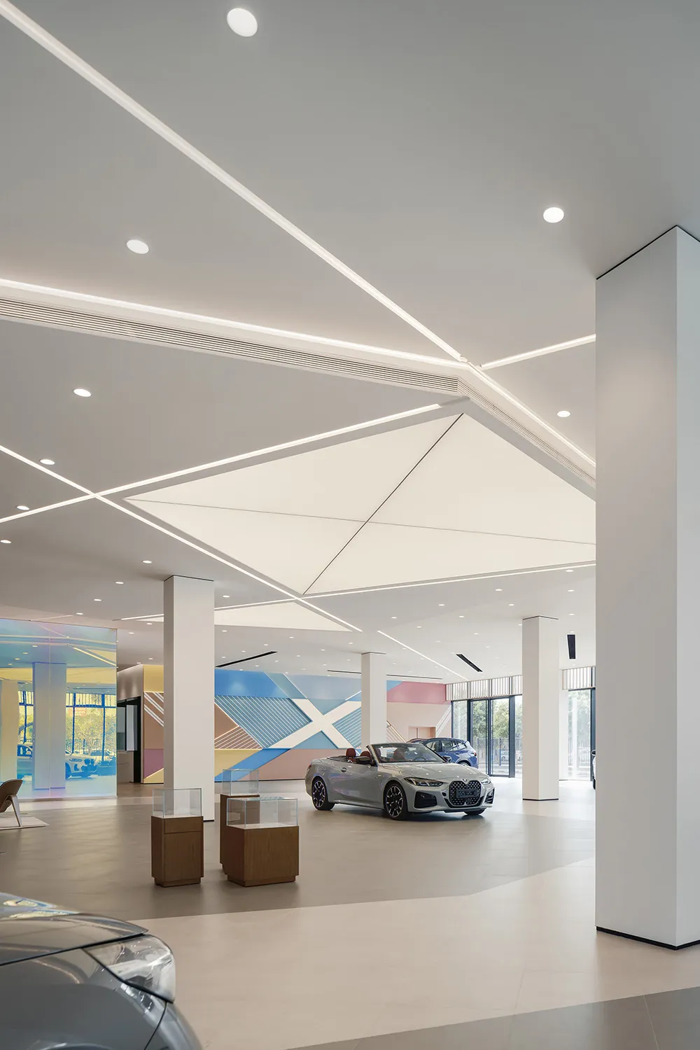 A modern car showroom featuring contemporary design elements and a sleek, minimalist aesthetic.