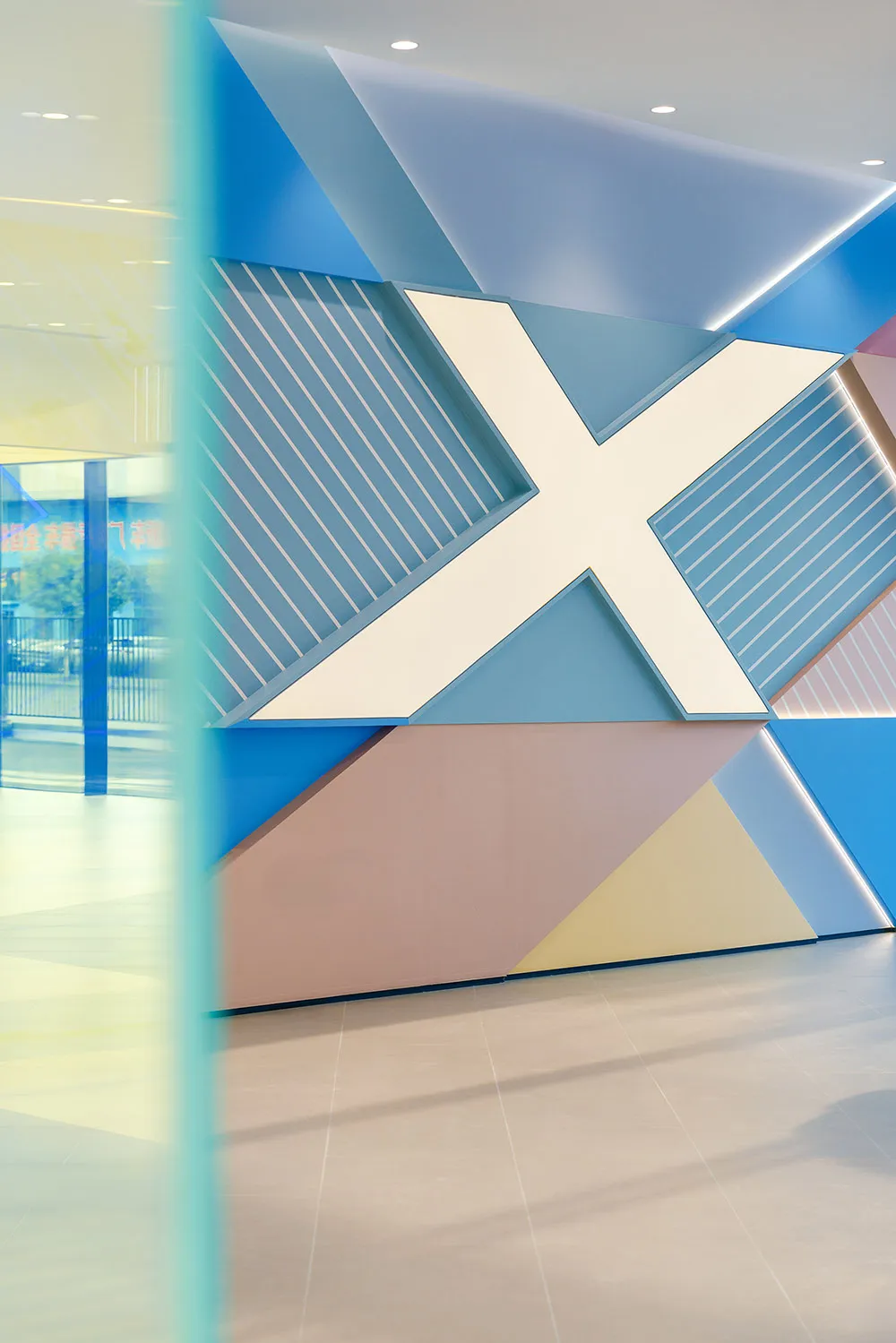 A modern interior featuring geometric patterns with a mix of blue, pink, and yellow colors.