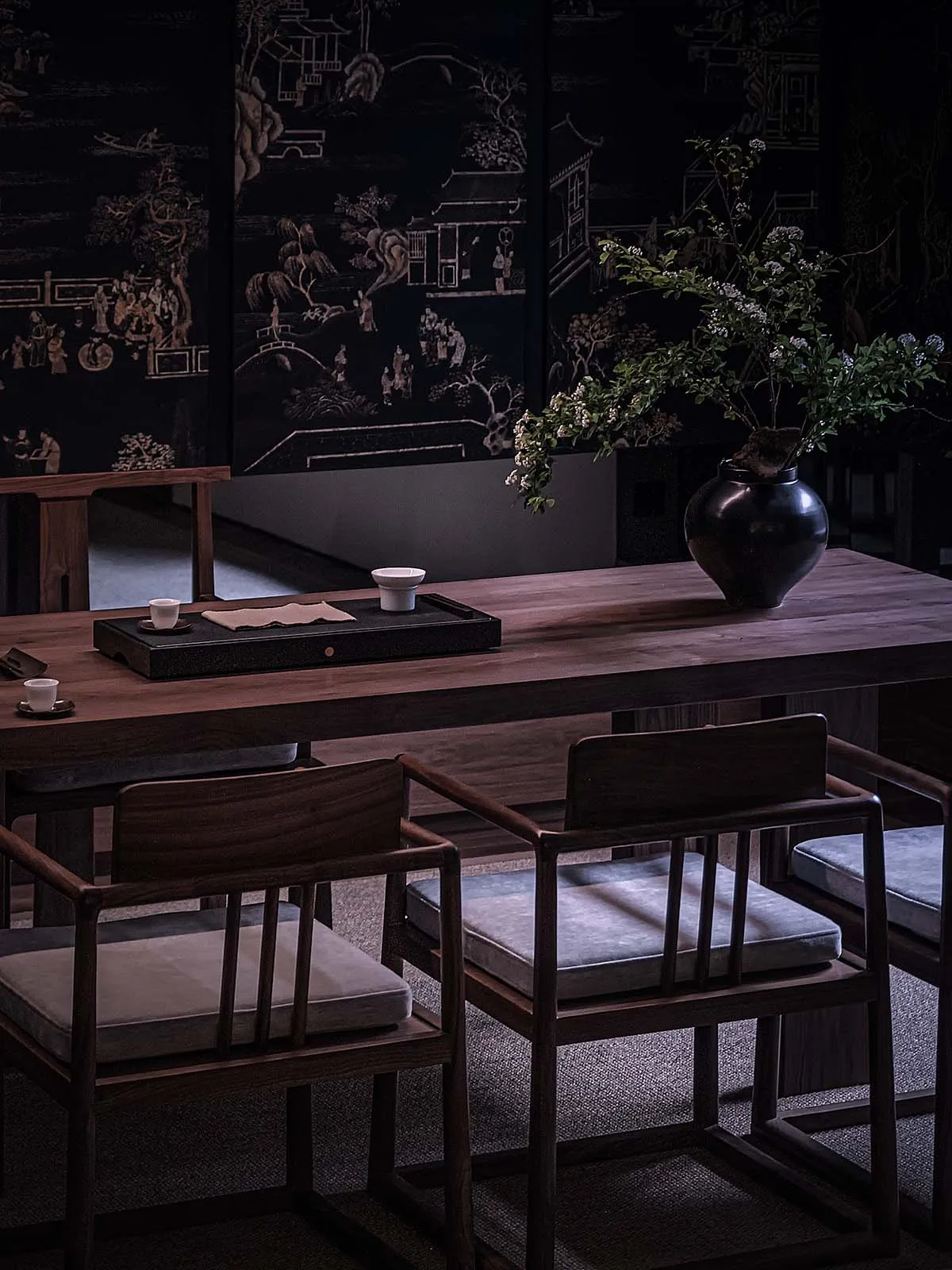A cozy coffee shop interior with wooden furniture and decorative plants.