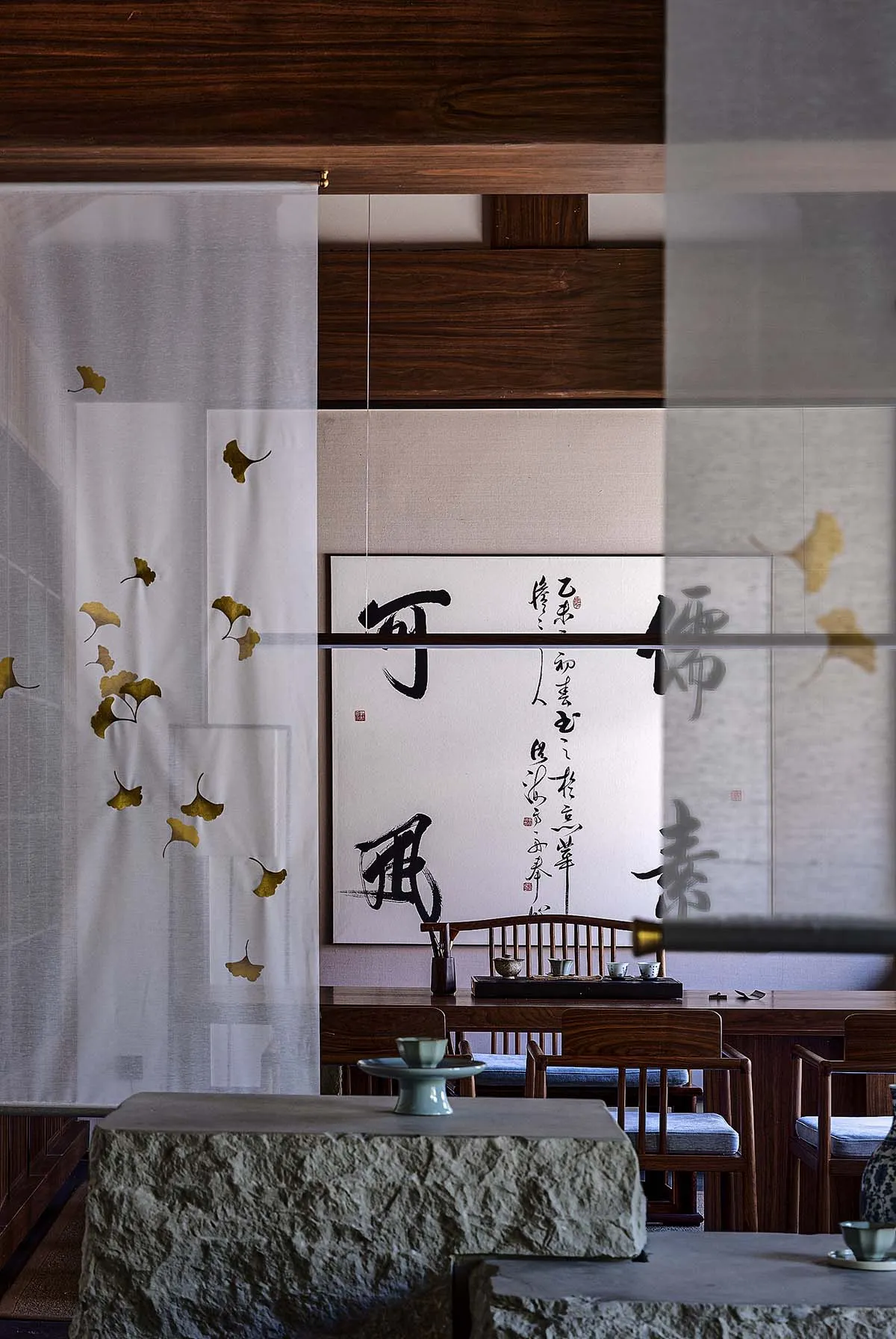 A minimalist tea room with wooden furniture and decor.