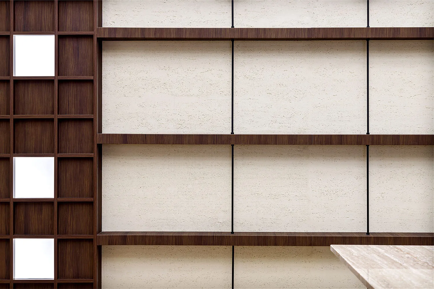 Modern, minimalist bookshelf with wooden shelves against a textured wall background.