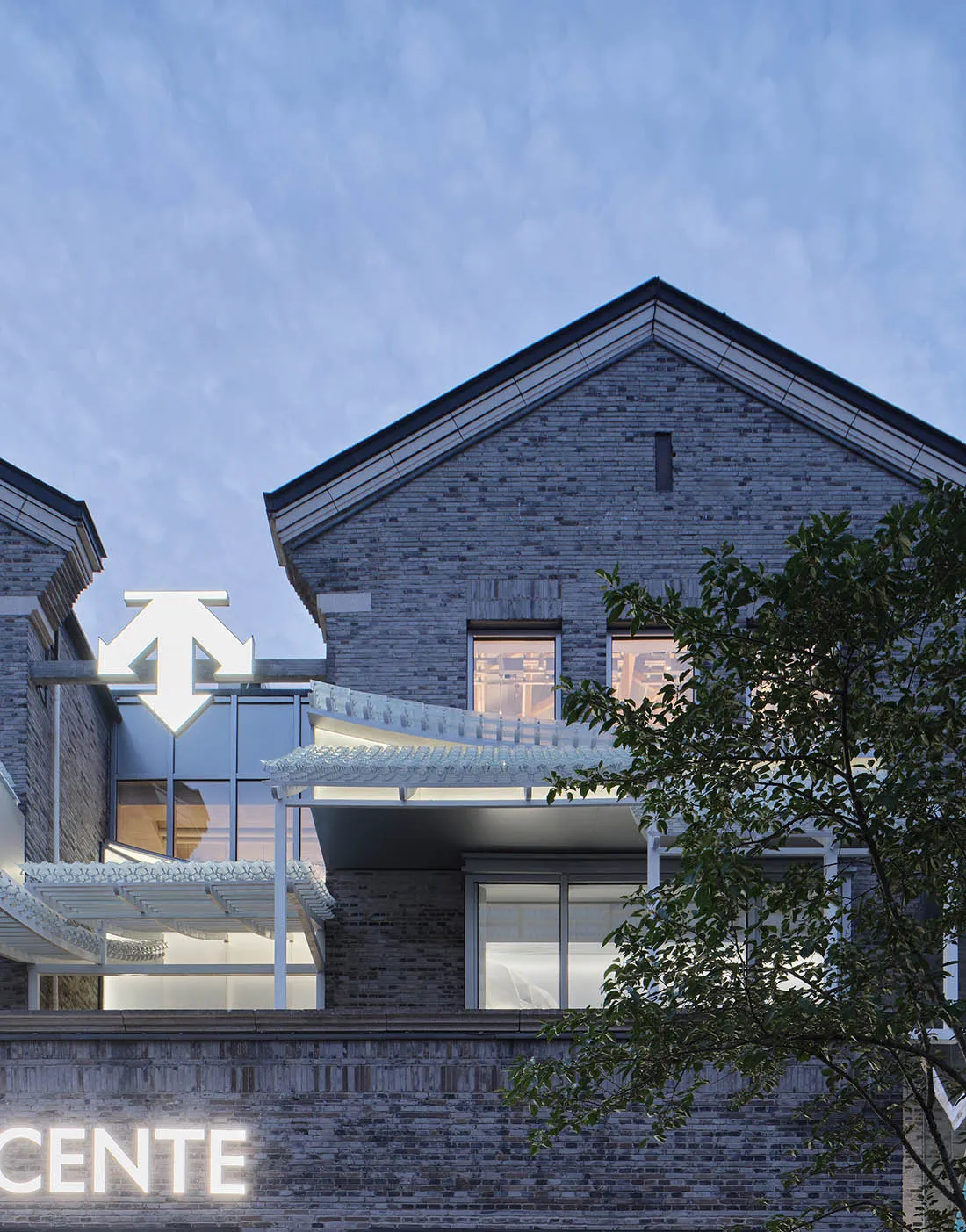 A contemporary brick building with large glass windows and a modern design.
