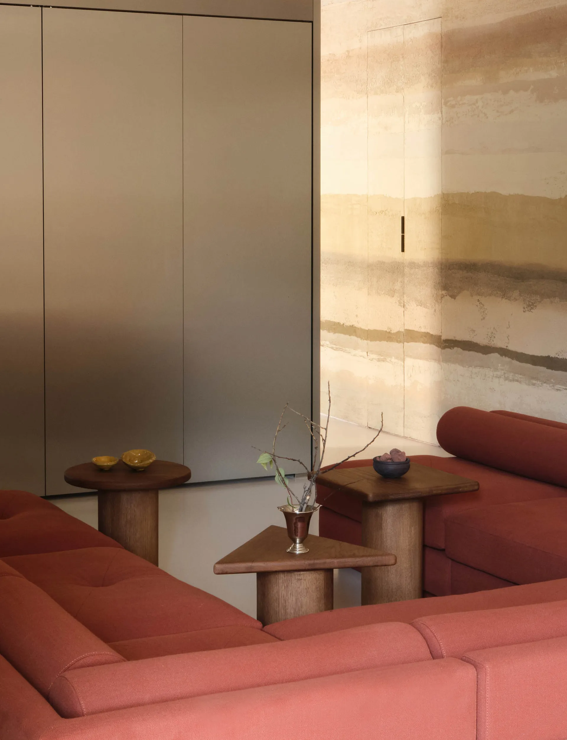 Modern sofa in a minimalist living room with a fabric upholstery and wooden furniture.