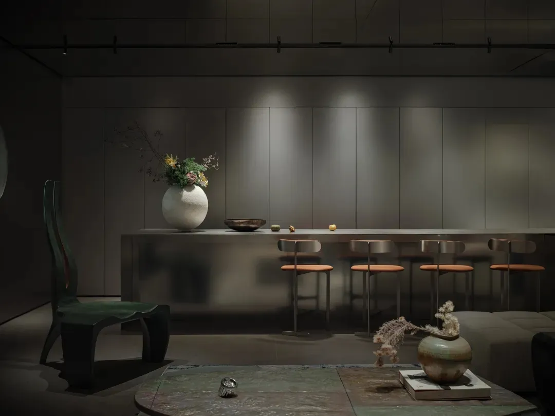 A modern minimalist living room featuring concrete, metal, and wood materials.