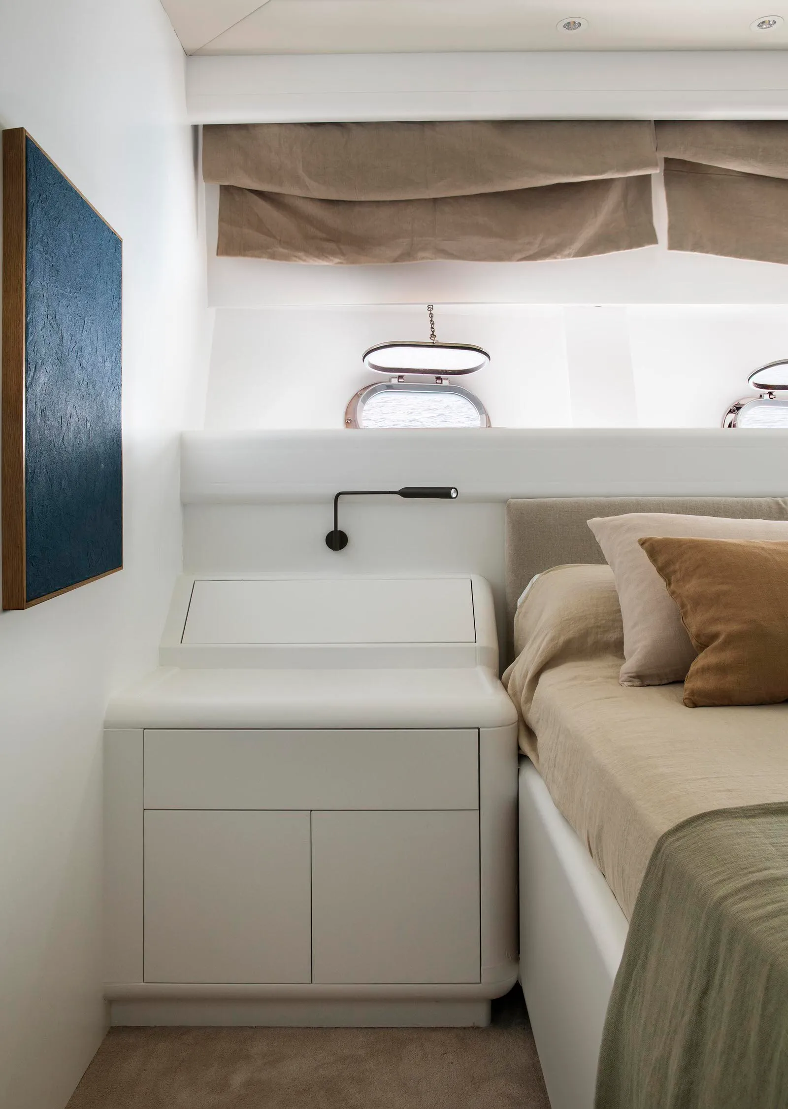 Bedroom with a minimalist interior design featuring neutral tones and a bed with pillows.