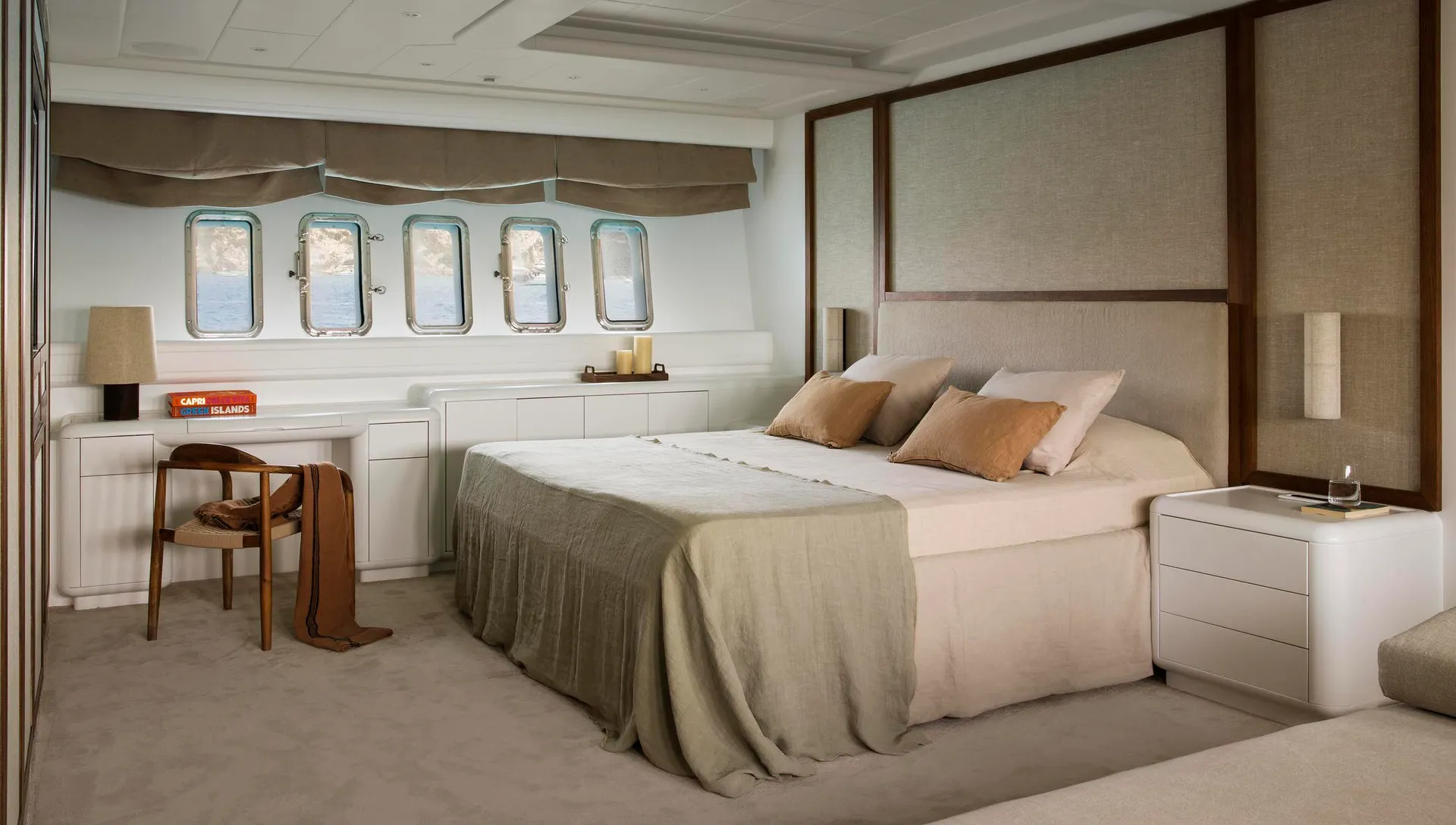 Modern bedroom with minimalistic design, featuring fabric bedding, wooden headboard, and stainless steel fixtures.