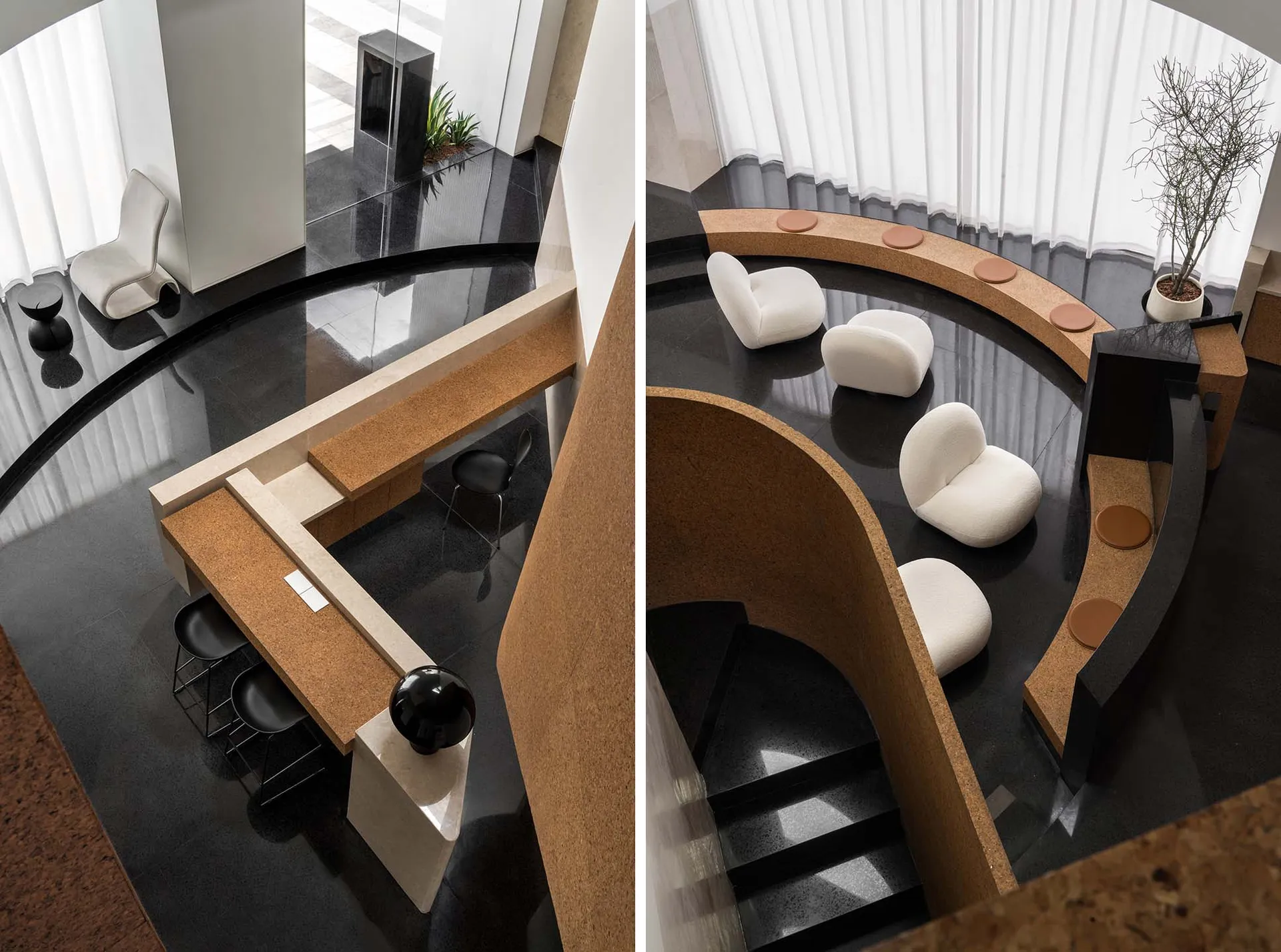 A modern office space with a glass wall, wooden desk, and white chairs.