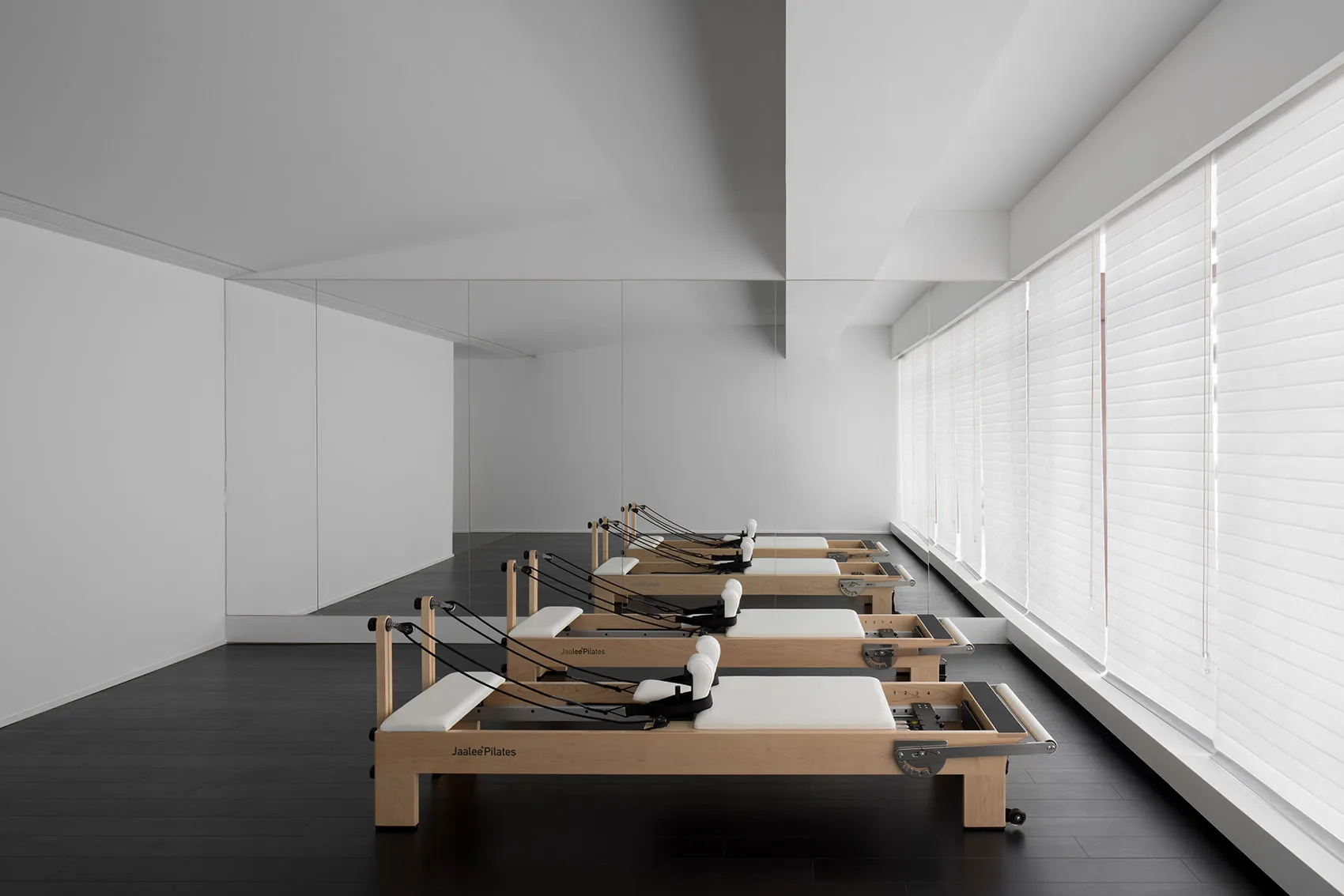 Minimalist fitness center with wooden frames and white equipment