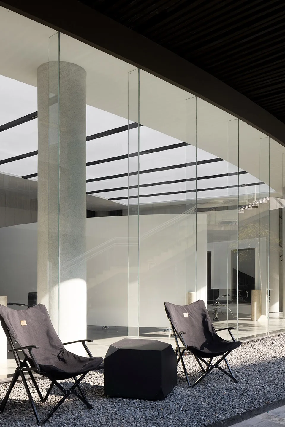 Modern office space with glass and concrete walls.