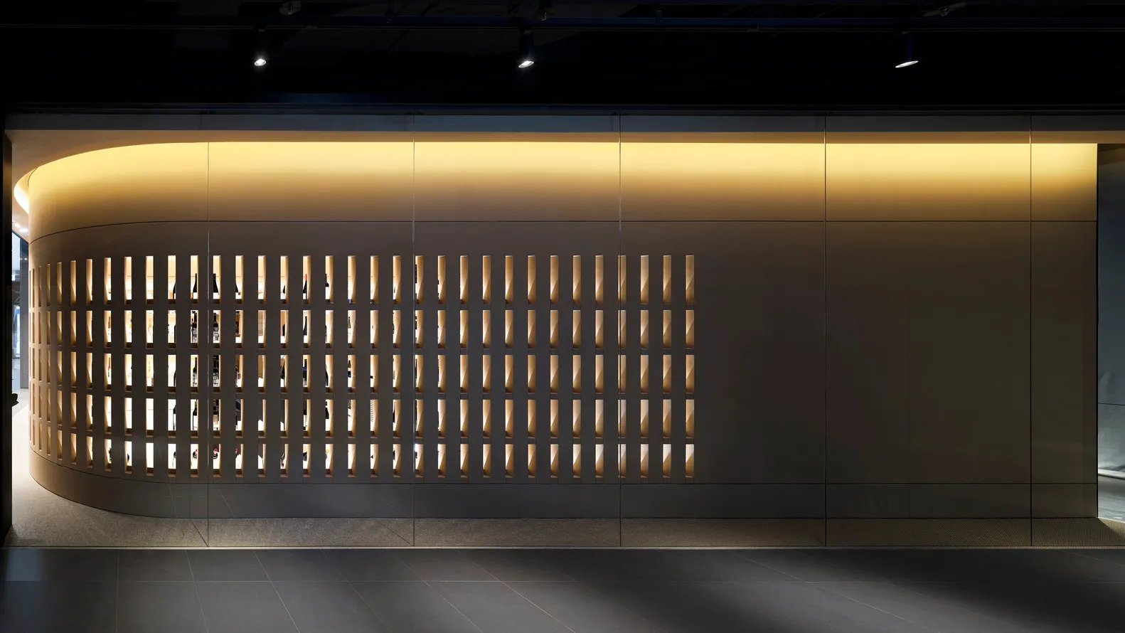 A modern retail storefront with a metallic grid design.