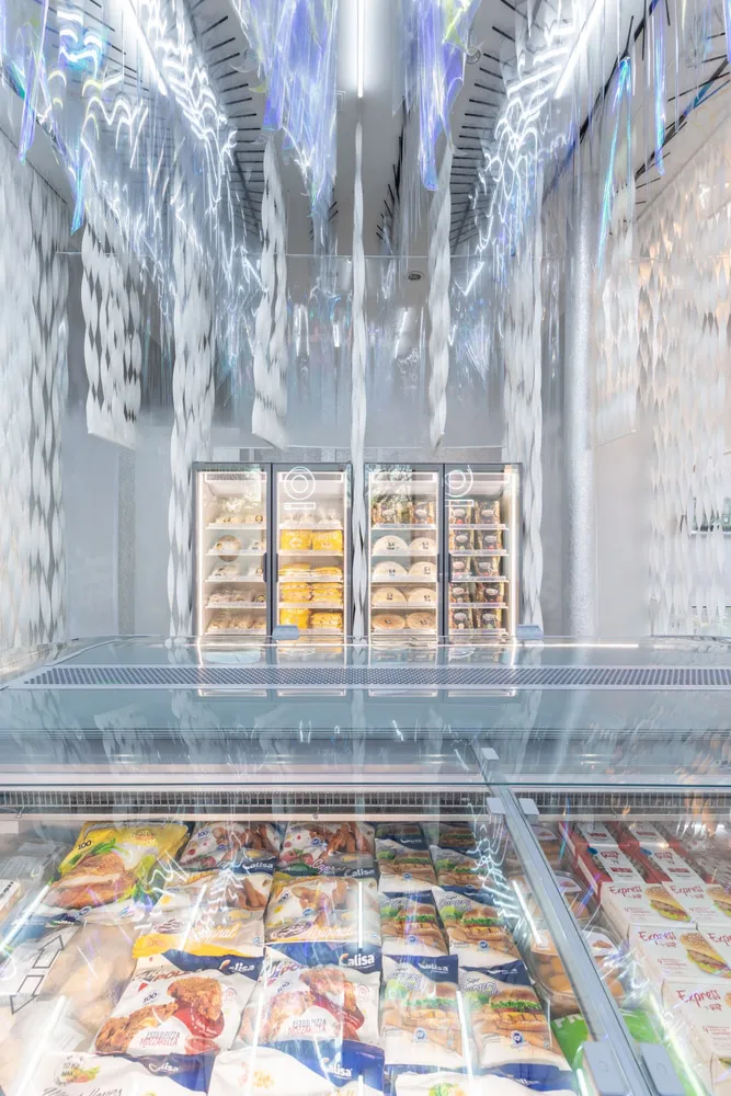 Minimalist grocery store interior with transparent glass walls and ceiling.