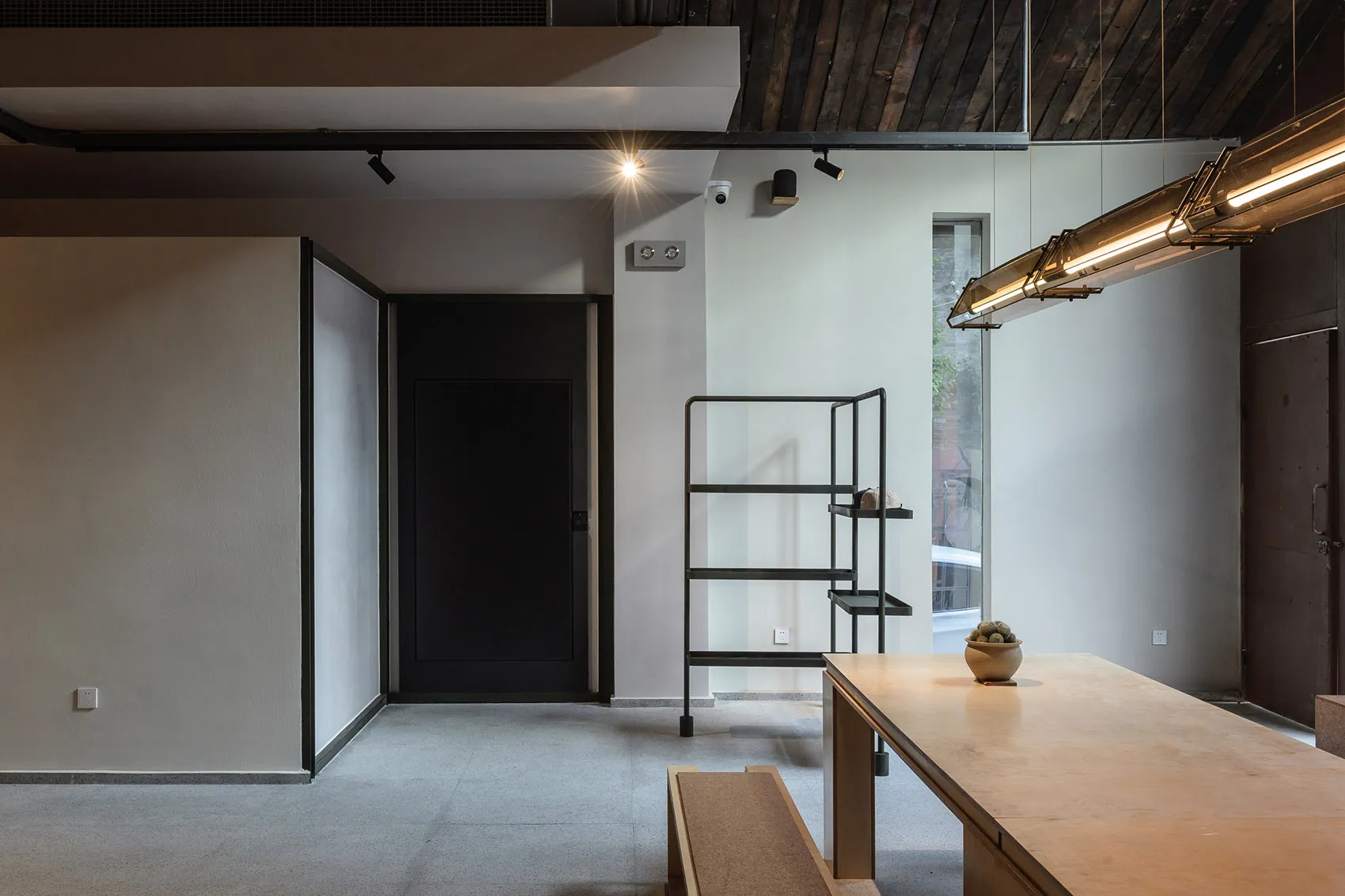 A modern commercial space with concrete flooring and minimalist design features.
