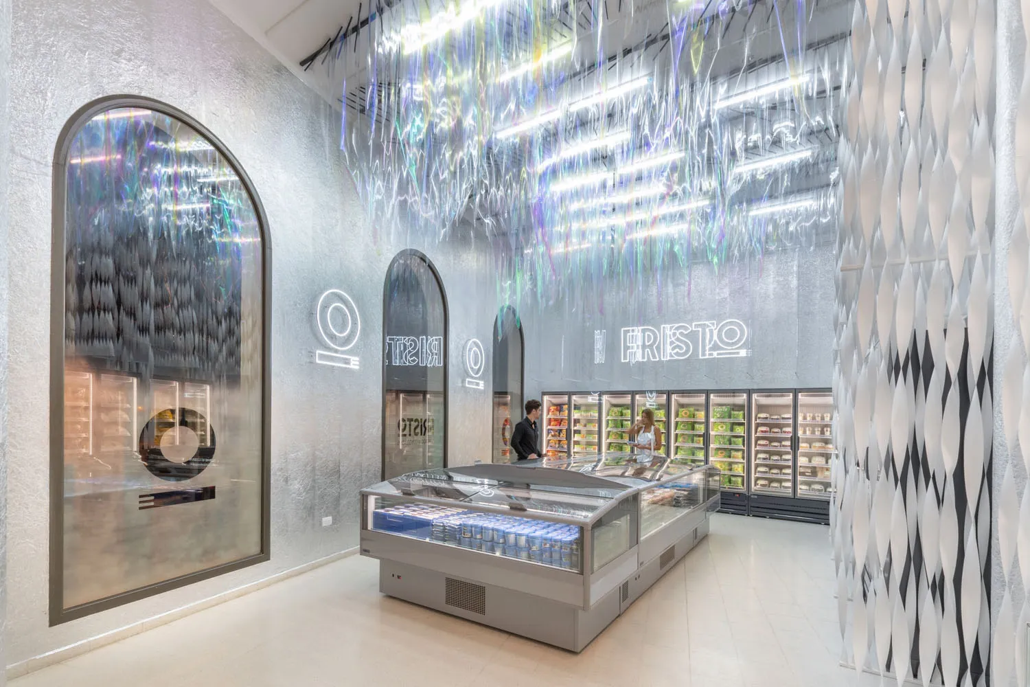A modern grocery store interior with metallic surfaces and a geometric design.